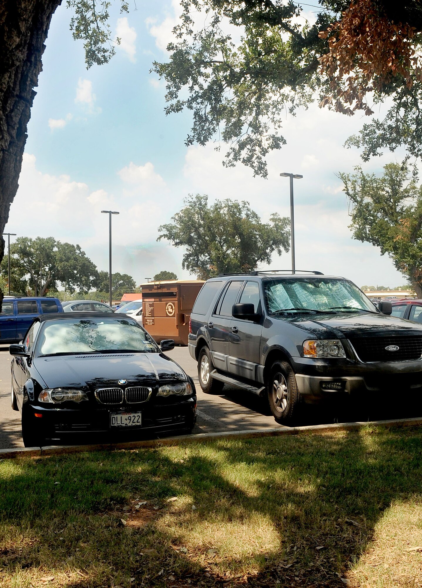 Members of Barksdale try to prevent seats from overheating and damage to vehicle interiors by combing sun shades and tree shade here August 2. With the temperature hitting above 100 degrees early in the day, members on base are trying to avoid as much heat and sweat as possible. (U.S. Air Force photo by Senior Airman Amber Ashcraft) (RELEASED)