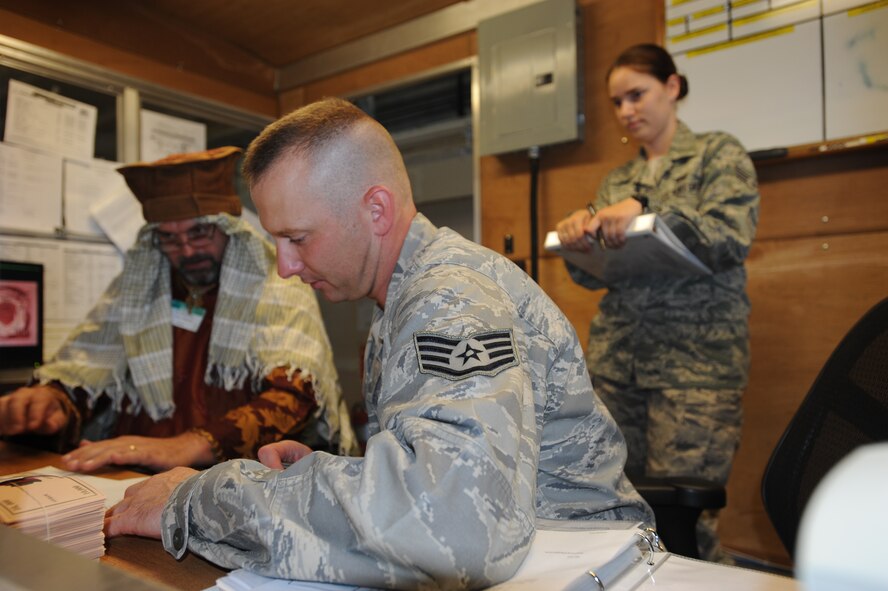 Staff Sgt. Billy Beck, a quality assurance specialist and this year’s Rodeo finance team lead with the 436th Comptroller Squadron, worked with a local bank teller at a simulated deployed environment at Joint Base Lewis-McChord, Wash. Senior Airman Tracey Wootton, a budget analyst with the 436 CPTS, acted as a cashier and escort for this scenario. This year was the first year a financial team took part in Air Mobility Command’s Rodeo Competition.  (U.S. Air Force photo by 2nd Lt. Jennifer Guerrero)