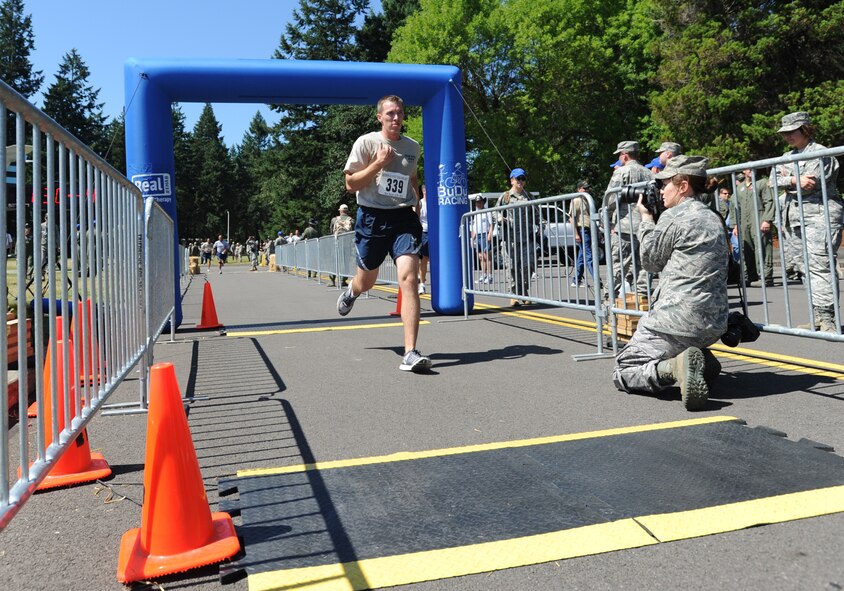 Staff Sgt. Brian Lecates, a patrolman with 436th Security Forces Squadron, crosses the finish line during the Fit to Fight Fitness Test at the 2011 Air Mobility Command Rodeo competition. This fitness test contributed to the Best Airland Team Award received by Team Dover at the 2011 Rodeo Competition. (U.S. Air Force photo by 2nd Lt. Jennifer Guerrero)