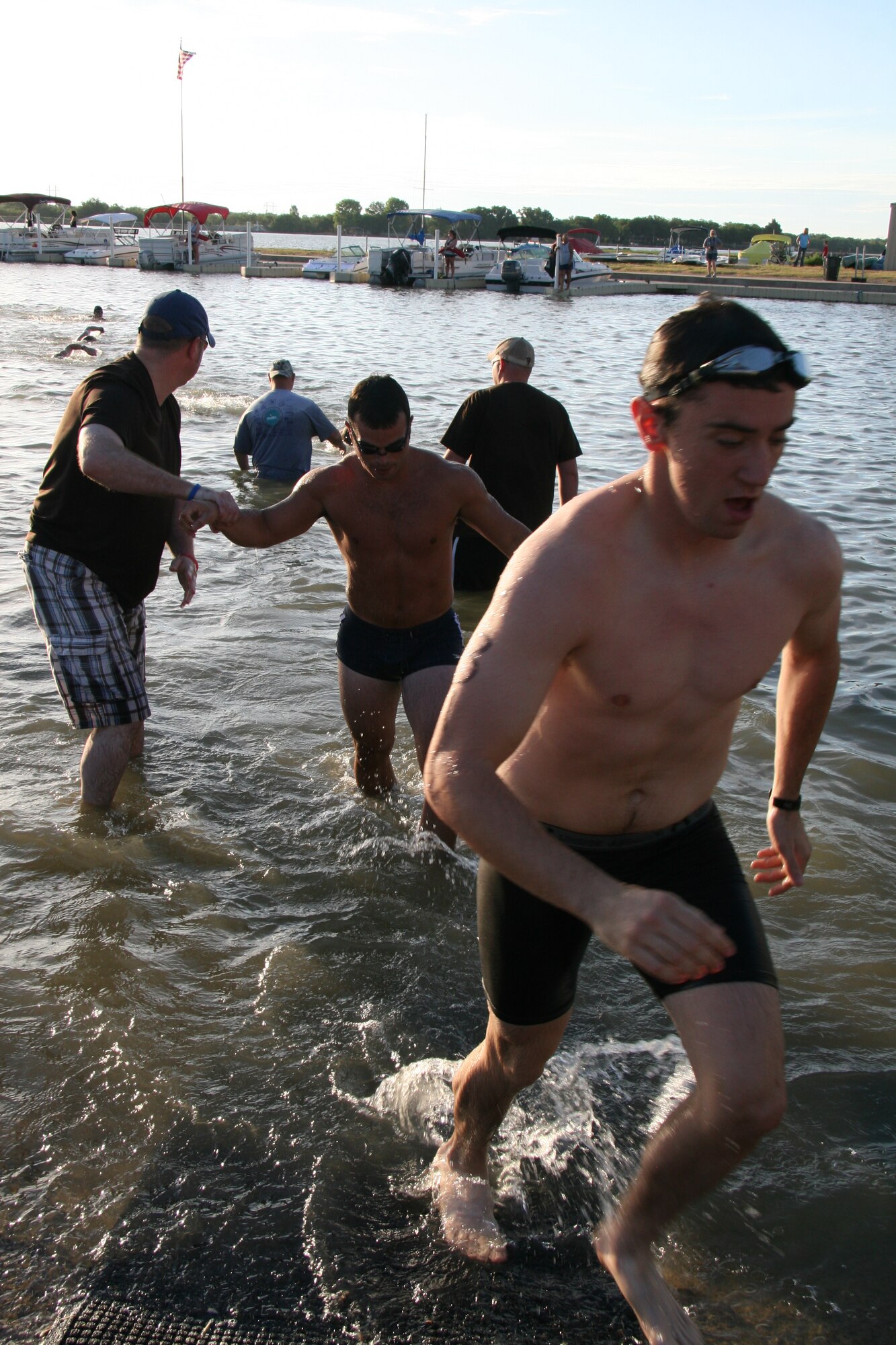 GOODFELLOW AIR FORCE BASE, Texas – Swimmers transition from the 400-meter open water swim to the 20-kilometer bike ride portion of 2011 Triathlon at the Outdoor Recreation Camp July 30. (Courtesy photo/Julie Manuel)