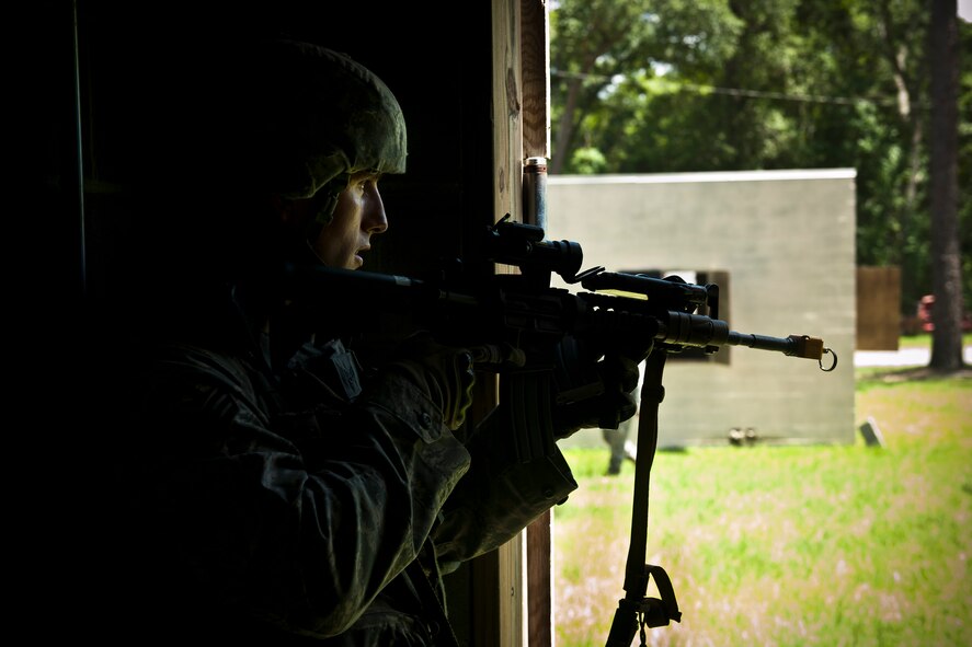 U.S. Air Force Senior Airman Jared Boucher, 96th Security Forces Squadron squad leader from Eglin, Air Force Base, Fla., scans the area for any opposing forces during the squad leadership course at Moody Air Force Base, Ga., July 29, 2011. Airman Boucher was tasked to lead nine individuals into the military operations in urban terrain village training facility, exchange information with the village leader and conduct his team in a tactical manner while under fire from opposing forces. (U.S. Air Force photo by Airman 1st Class Joshua Green/Released)
