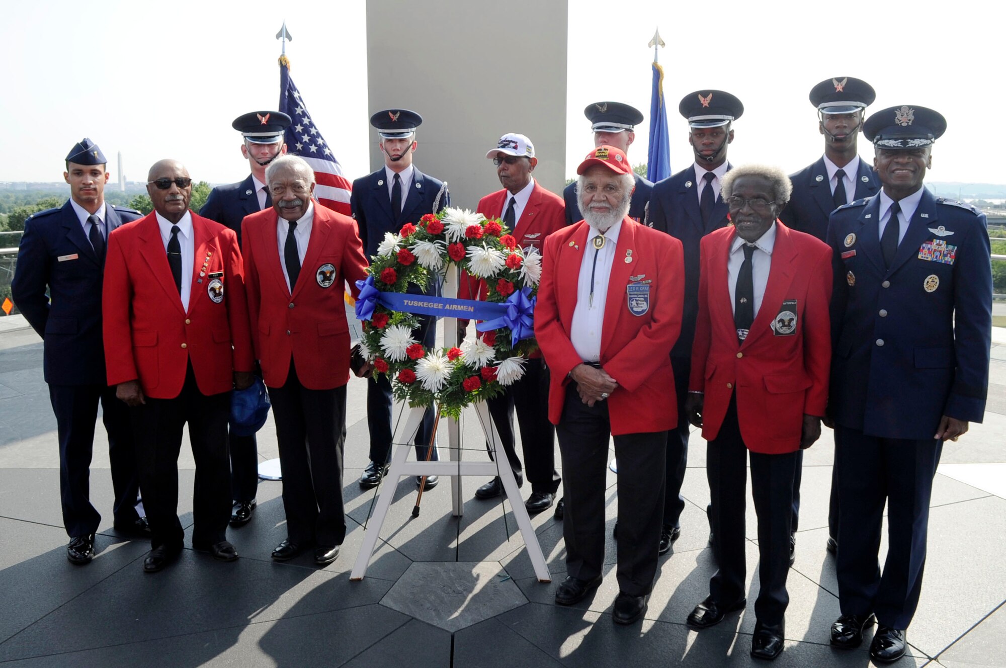 Maj. Gen. Darren W. McDew, Air Force District of Washington commander, and members of the U.S. Air Force Honor Guard, join Tuskegee Airmen Association members at a wreath laying ceremony July 31 at the Air Force Memorial in Washington, D.C. The Tuskegee Airmen were the first African American military aviators in the United States armed forces. The Tuskegee Airmen flew with the 332nd Fighter Group, the only operational unit first sent overseas as part of Operation Torch, then in action in Sicily and Italy, before being deployed as bomber escorts where they were particularly successful in their missions. (U.S. Air Force photo by Staff Sgt. Raymond Mills) 