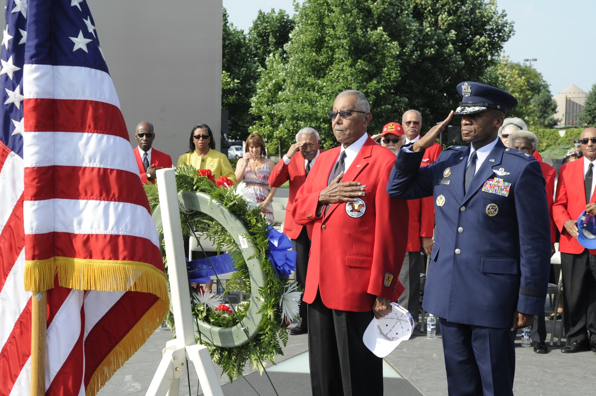 Maj. Gen. Darren W. McDew, Air Force District of Washington commander, and Jim Pryde, a Tuskegee Airman, lay a wreath July 31 at the U.S. Air Force Memorial in Washington, D.C. Pryde served with the Army Air Corps 477th Medium Bombardment Group as a combat crewman. During his tenure, he accrued 1,600 flight hours before continuing his civil service career as an intelligence analyst with the Armed Forces Security Agency. (U.S. Air Force photo by Staff Sgt. Raymond Mills)