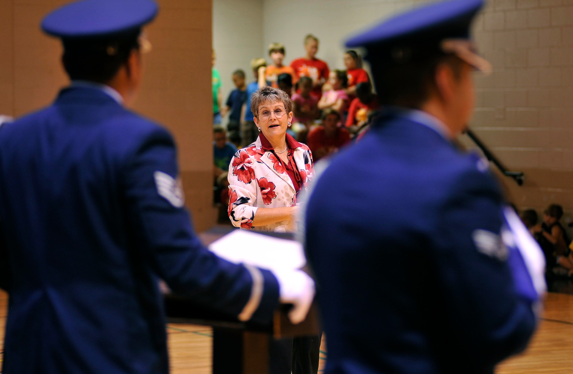 Mrs. Kelly Sexton, YMCA of Sumter director of youth development, asks members of the Shaw Air Force Base Honor Guard questions about flag etiquette, during the Q-and-A portion of a flag folding ceremony Aug. 2, 2011, Sumter S.C. The Shaw Honor Guard performed a flag folding presentation for more than 100 local children to teach them proper flag etiquette. (U.S. Air Force photo by Senior Airman Kenny Holston)(Released)

