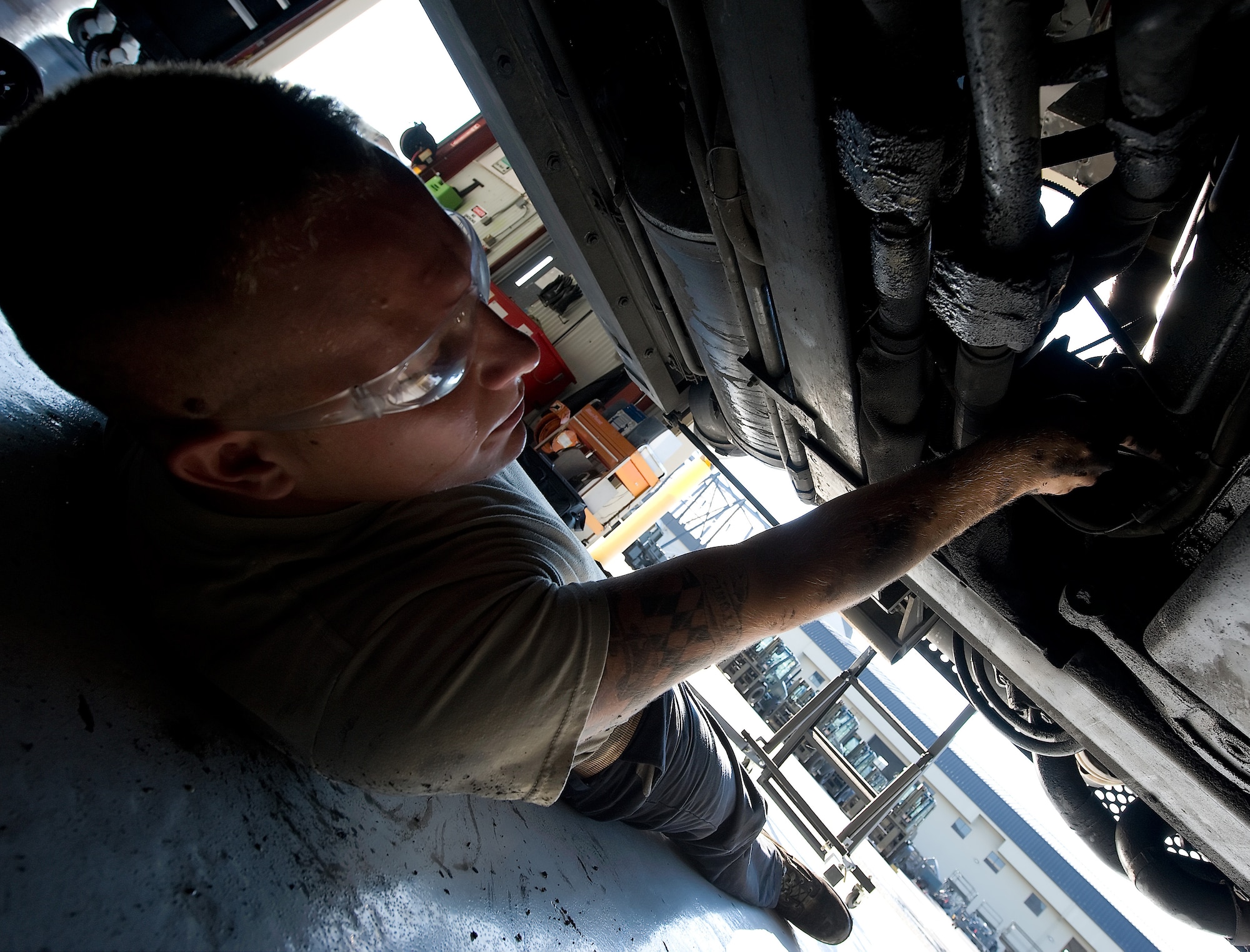 Senior Airman Sammy Anderson, a material handling equipment journeyman with the 436th Logistics Readiness Squadron, removes bolts from the carriage to release the starter on a 60,000 pound cargo loader July 27, 2011, at Dover Air Force Base, Del. The 60K loader is the biggest piece of machinery the material handling equipment maintenance shop works on. (U.S. Air Force photo by Steve Kotecki)
