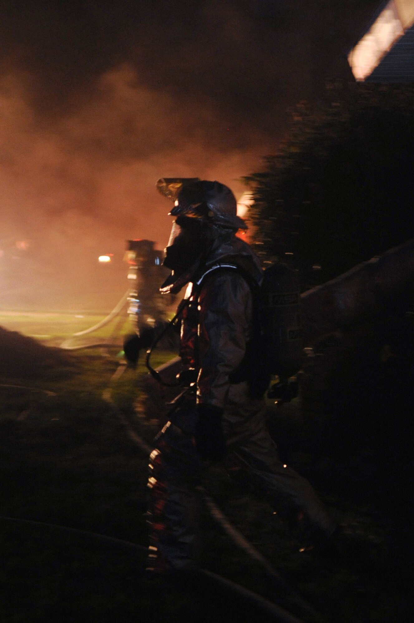 Firefighters with the 2nd Civil Engineer Squadron respond to a simulated fire in the old east side housing area on Barksdale Air Force Base, La., July 28, which is scheduled for demolition. Four houses were used to simulate two fires, a building collapse and a gas leak. (U.S. Air Force photo/Senior Airman La'Shanette V. Garrett) (RELEASED)