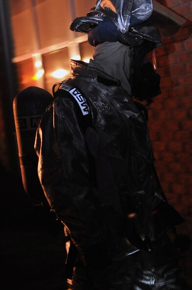 A firefighter with the 2nd Civil Engineer Squadron responds to a simulated fire in the old east side housing area on Barksdale Air Force Base, La., July 28, which is scheduled for demolition. The scenario was part of a joint training exercise between Barksdale firefighters and the Bossier City firefighters. (U.S. Air Force photo/Senior Airman La'Shanette V. Garrett) (RELEASED)