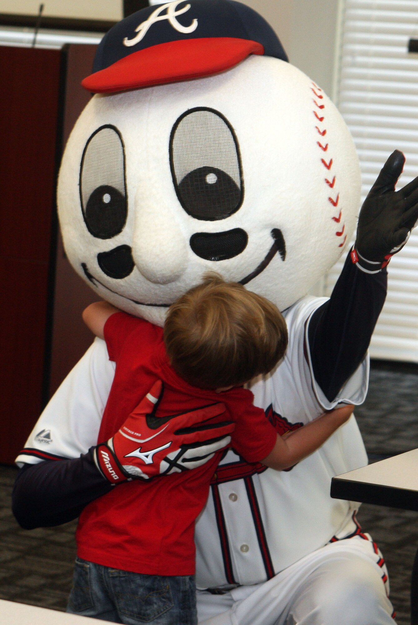 Homer, the Atlanta Braves mascot received hugs and high-fives from family members during his visit at "Take your kids to work day" here July 29, 2011. (U.S. Air Force Photo/Don Peek)