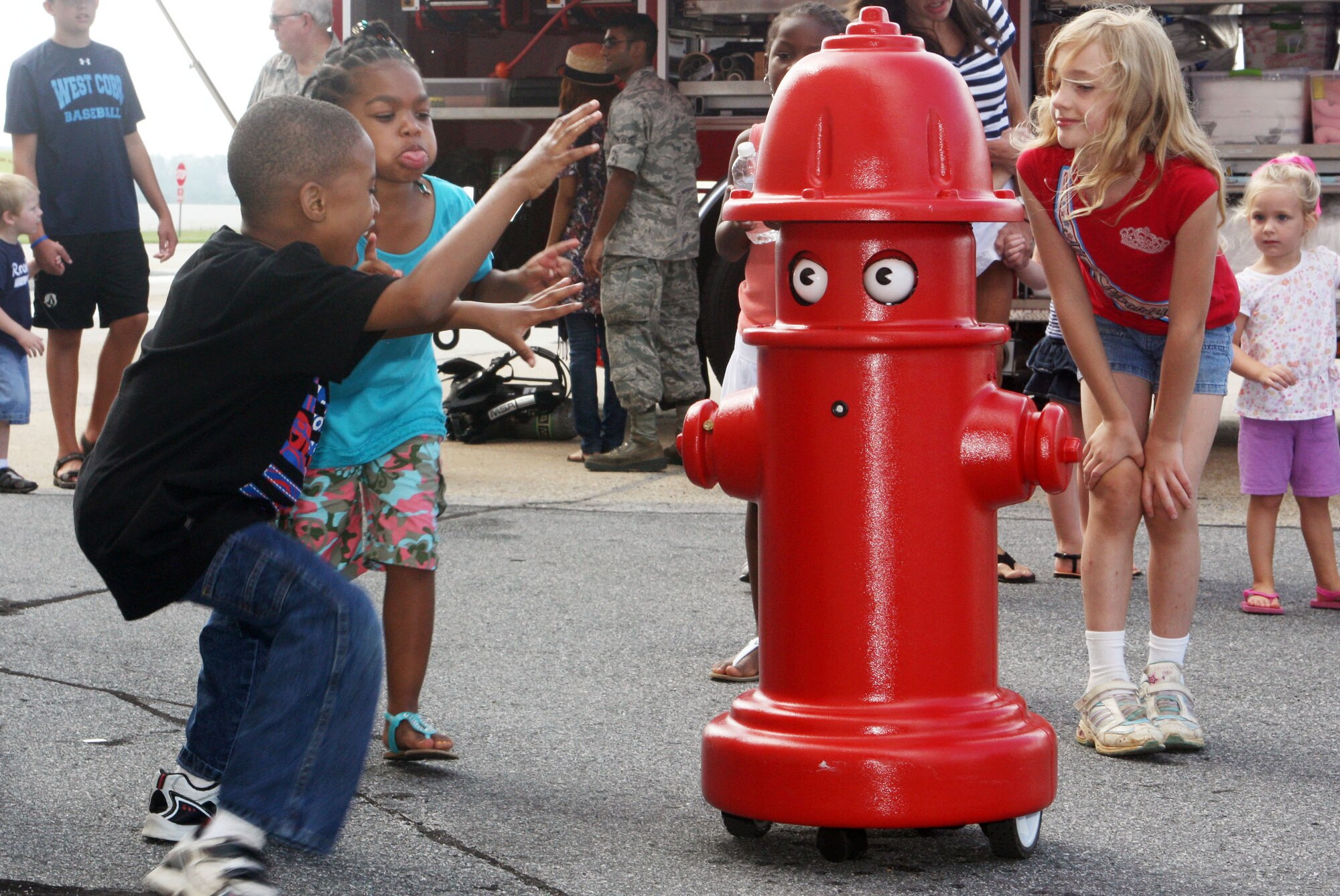 "Pluggie" the robotic spokesman from the 94th Civil Engineer Squadron, Fire Department, was a huge hit with the kids. (U.S. Air Force Photo/Don Peek)