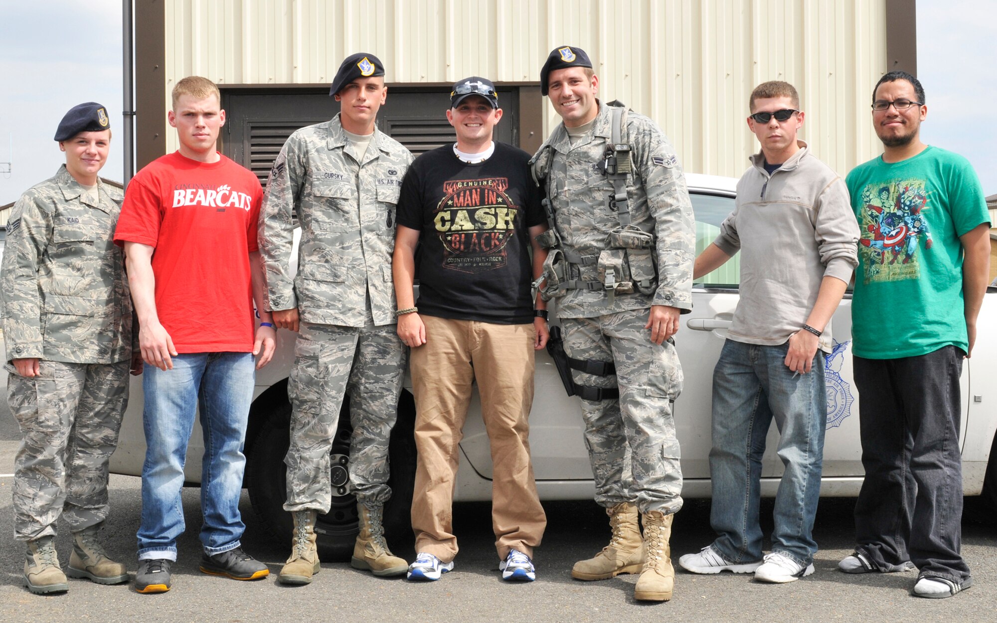 ROYAL AIR FORCE LAKENHEATH, England - Staff Sgt. Kristoffer Schneider, 48th Security Forces Squadron senior patrolman (center), stands with members of his team upon his return to RAF Lakenheath, Aug. 1, 2011. Schneider returned following his recovery from wounds sustained during the March shooting at Frankfurt International Airport. (U.S. Air Force photo/Senior Airman Tiffany M. Deuel)