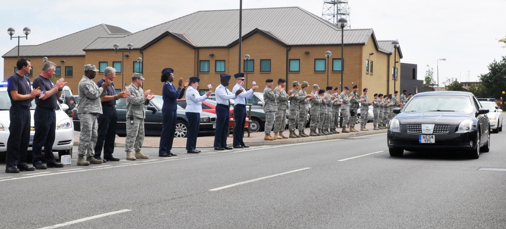 ROYAL AIR FORCE LAKENHEATH, England - Airmen and civilians applaud the return of Staff Sgt. Kristoffer Schneider, 48th Security Forces Squadron senior patrolman, to RAF Lakenheath, Aug. 1, 2011. Schneider returned following his recovery from wounds sustained during the March shooting at Frankfurt International Airport. (U.S. Air Force photo/Senior Airman Tiffany M. Deuel)