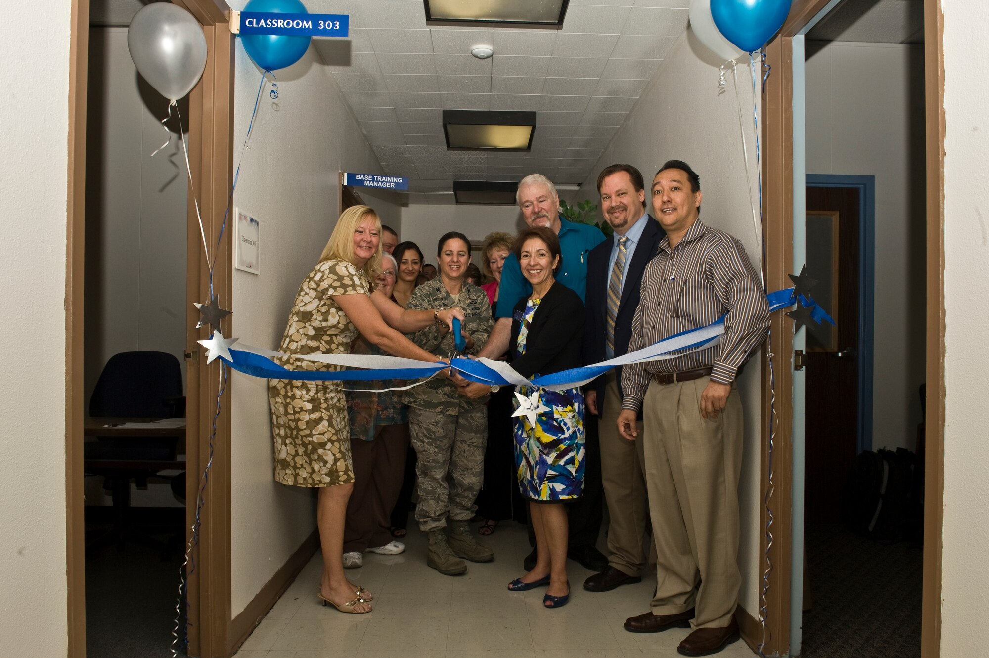 Ms. Julie Swan, 99th Force Support flight chief, U.S. Air Force Col. Carol Yannarella, 99th Air Base Wing vice commander, Mr. James Garvey, 99th Force Support Squadron deputy, Dr. Roxanne Gonzales, Academic Dean, Regis University, Mr. Kevin Miller, Campus Director, Regis University and Mr. William Ide, 99th Force Support Squadron test control officer, take part in a ribbon cutting ceremony to open the Nellis National Test Center July 28, 2011, at Nellis Air Force Base, Nev. The test center will allow eligible military and civilian members to receive college credit by earning qualifying scores on the college-level examination program computer-based tests and DANTES subject to standardized tests. (U.S. Air Force photo by Airman 1st Class Daniel Hughes)