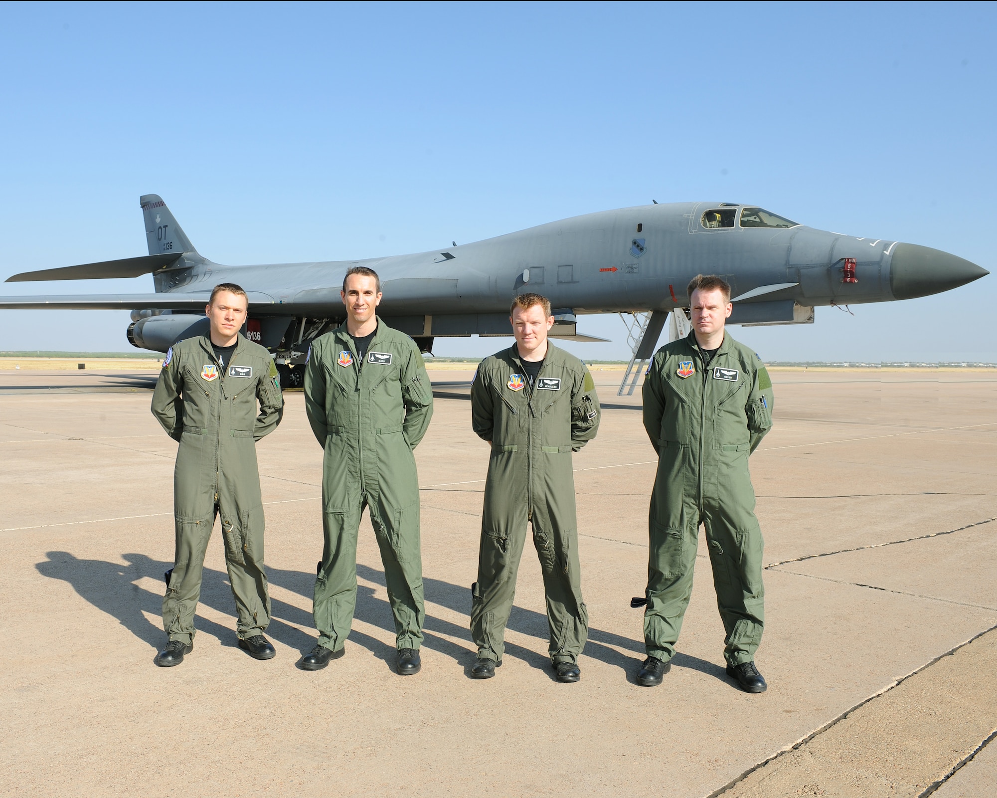 Students from the 77th Weapons School pose in front of a B-1 Bomber July 22, 2011 on the flight line Dyess AFB, Texas. In the past month, students have completed more than 75 hours of academic classes, one simulator mission featuring defensive tactics, three sortie flights including two-ship, daytime and formation defensive tactics, as well as one combat planning exercise. (U.S. Air Force photo by Tech. Sgt. Darcie Ibidapo/ Released)