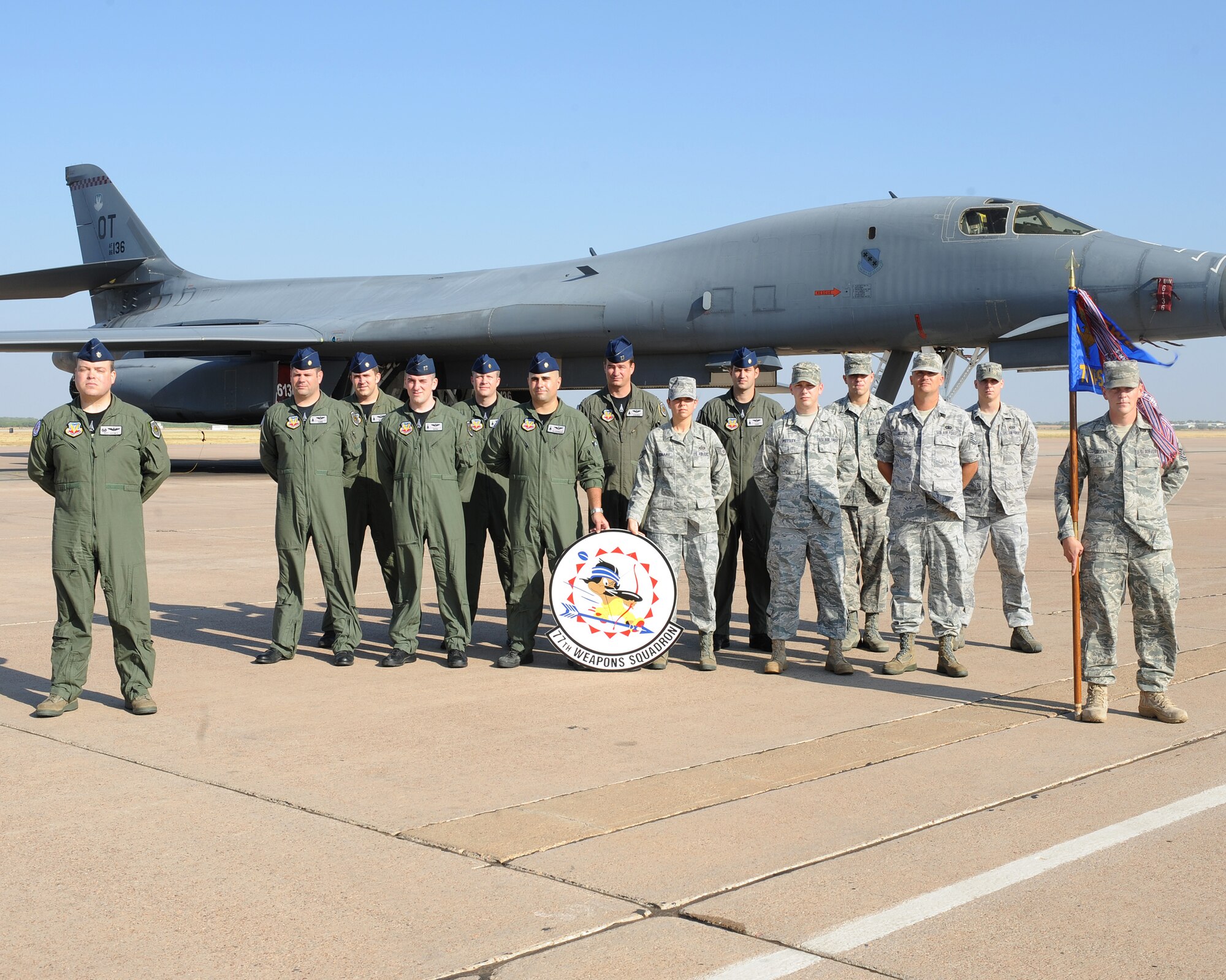 Members from the 77th Weapons Squadron pose in front of a B-1 Bomber July 22, 2011 on the flight line at Dyess AFB, Texas. The squadron supports the 77th Weapons School, which produces eight B-1 weapon officers a year. (U.S. Air Force photo by Tech. Sgt. Darcie Ibidapo/ Released)