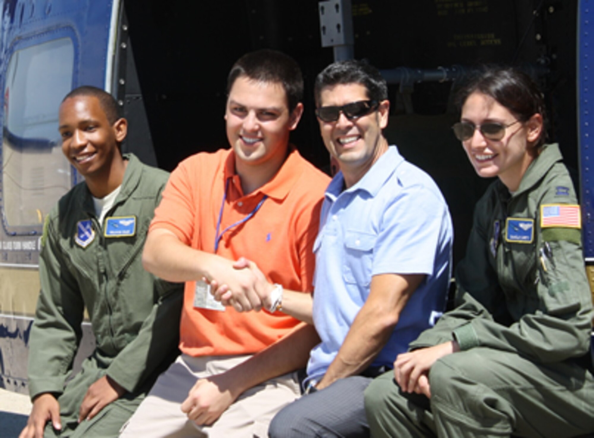 Captains Ben Osler and Danielle Caretti, UH-1 aircrew, 1st Helo Squadron, Joint Base Andrews, showed Science, Mathematics and Research for Transformation program Air Force liaison Ed Bujan (center right) and his recruit, Matt Spector, the inside of the UH-1 during the SMART orientation in Washington D.C. Spector, a California native, attends Abilene Christian University. (Courtesy photo/Matthew Rose, SMART Program)