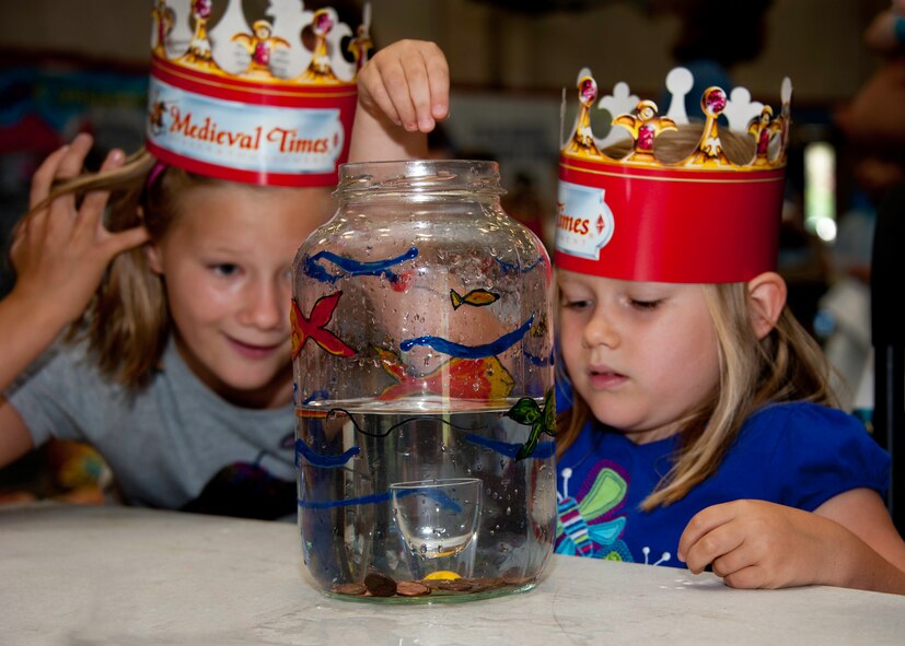 A little princess tries one of the many games at the medieval faire at the Eglin youth center July 29.  The “faire” was the culmination of the 2011 “A Midsummer Knight’s Read,” program held by the base library.  More than 180 children, parents, knights and ladies attended. (U.S. Air Force photo/Randy Gon)
