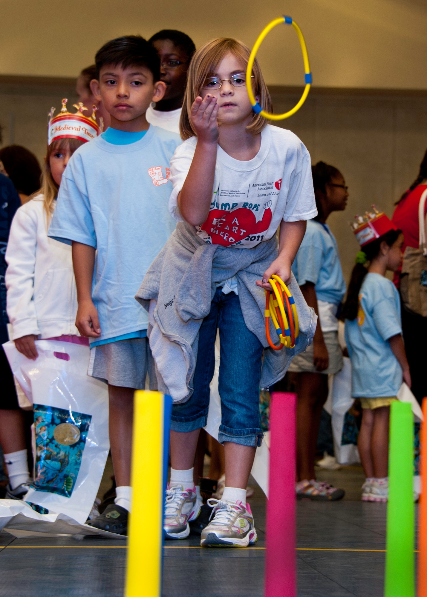 A child tries her luck at the ring toss during the medieval faire at the Eglin youth center July 29.  The "faire' was the culmination of the 2011 “A Midsummer Knight’s Read,” program held by the base library.  More than 180 children, parents, knights and ladies attended.  (U.S. Air Force photo/Randy Gon)  