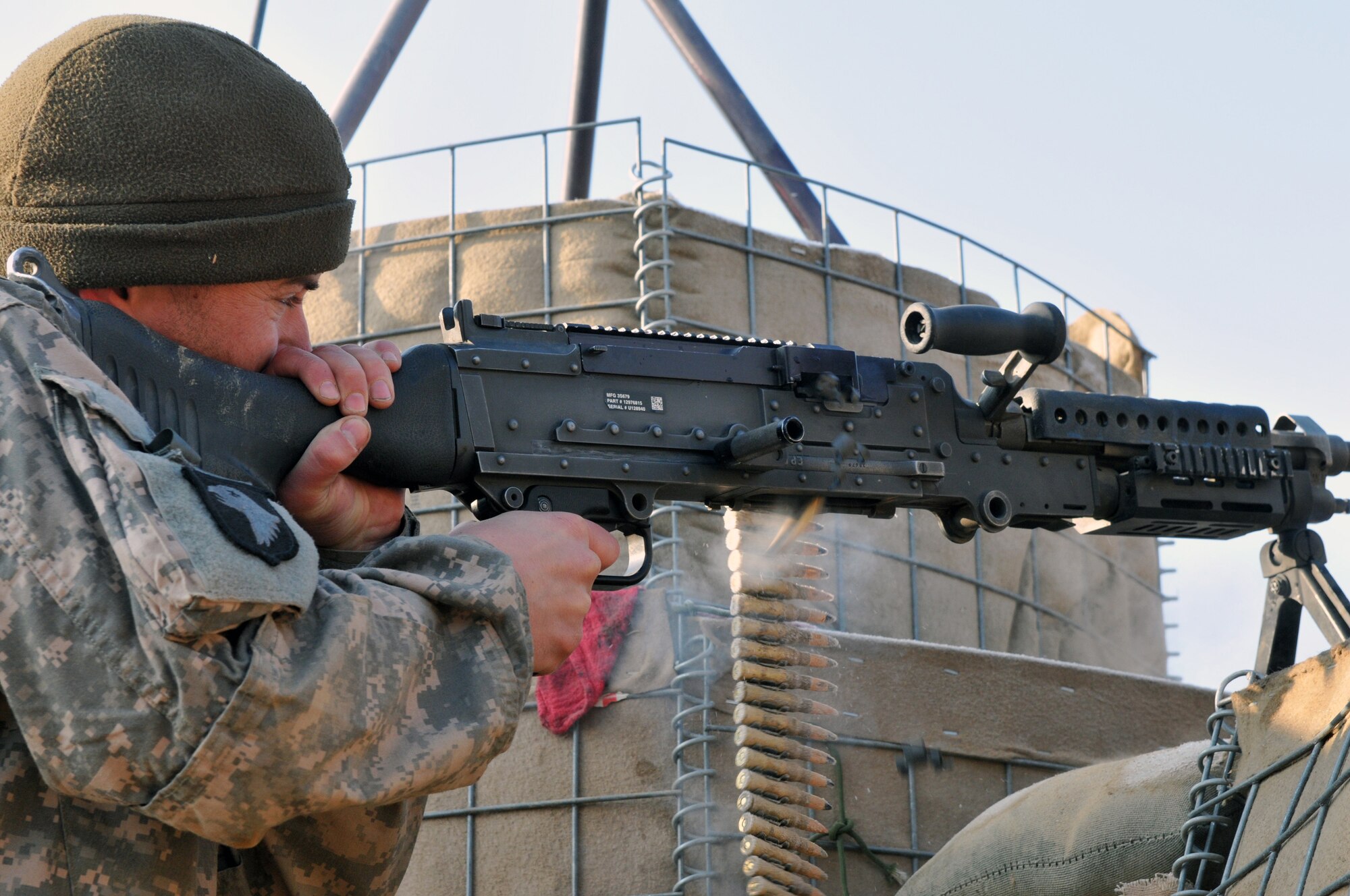 BALA MURGHAB, Afghanistan – Tech. Sgt. Kevin Wallace, Regional Command-West Media Combat Team photojournalist, fires a M-240B Machine Gun at Observation Post Cougar, Bala Murghab, Afghanistan, Jan. 15, 2011. White Platoon, 7th Squadron, 10th Cavalry Regiment scouts were responsible for securing the OP, and were frequently fended off insurgent assaults. (U.S. Navy photo/Mass Communications Specialist 1st Class John Pearl/RELEASED)