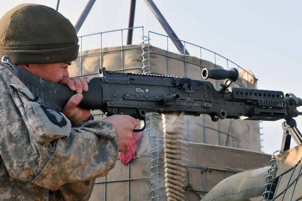 BALA MURGHAB, Afghanistan – Tech. Sgt. Kevin Wallace, Regional Command-West Media Combat Team photojournalist, fires a M-240B Machine Gun at Observation Post Cougar, Bala Murghab, Afghanistan, Jan. 15, 2011. White Platoon, 7th Squadron, 10th Cavalry Regiment scouts were responsible for securing the OP, and were frequently fended off insurgent assaults. (U.S. Navy photo/Mass Communications Specialist 1st Class John Pearl/RELEASED)
