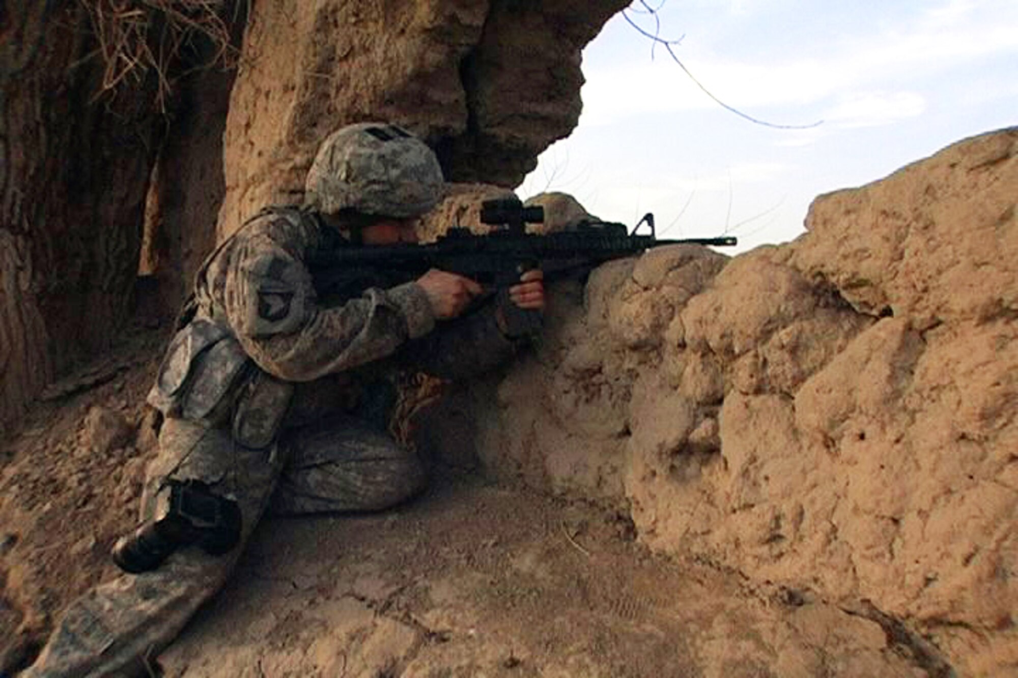 BALA MURGHAB, Afghanistan – Tech. Sgt. Kevin Wallace, Regional Command-West Media Combat Team photojournalist, secures a sector of fire after his team of 7th Squadron, 10th Cavalry Regiment scouts took fire during a reconnaissance patrol in Bala Murghab, Afghanistan, Jan. 9, 2011. The team was attacked along a riverbed and moved to cover in ruins until close-air support arrived. (U.S. Navy photo/Mass Communications Specialist 1st Class John Pearl/RELEASED)