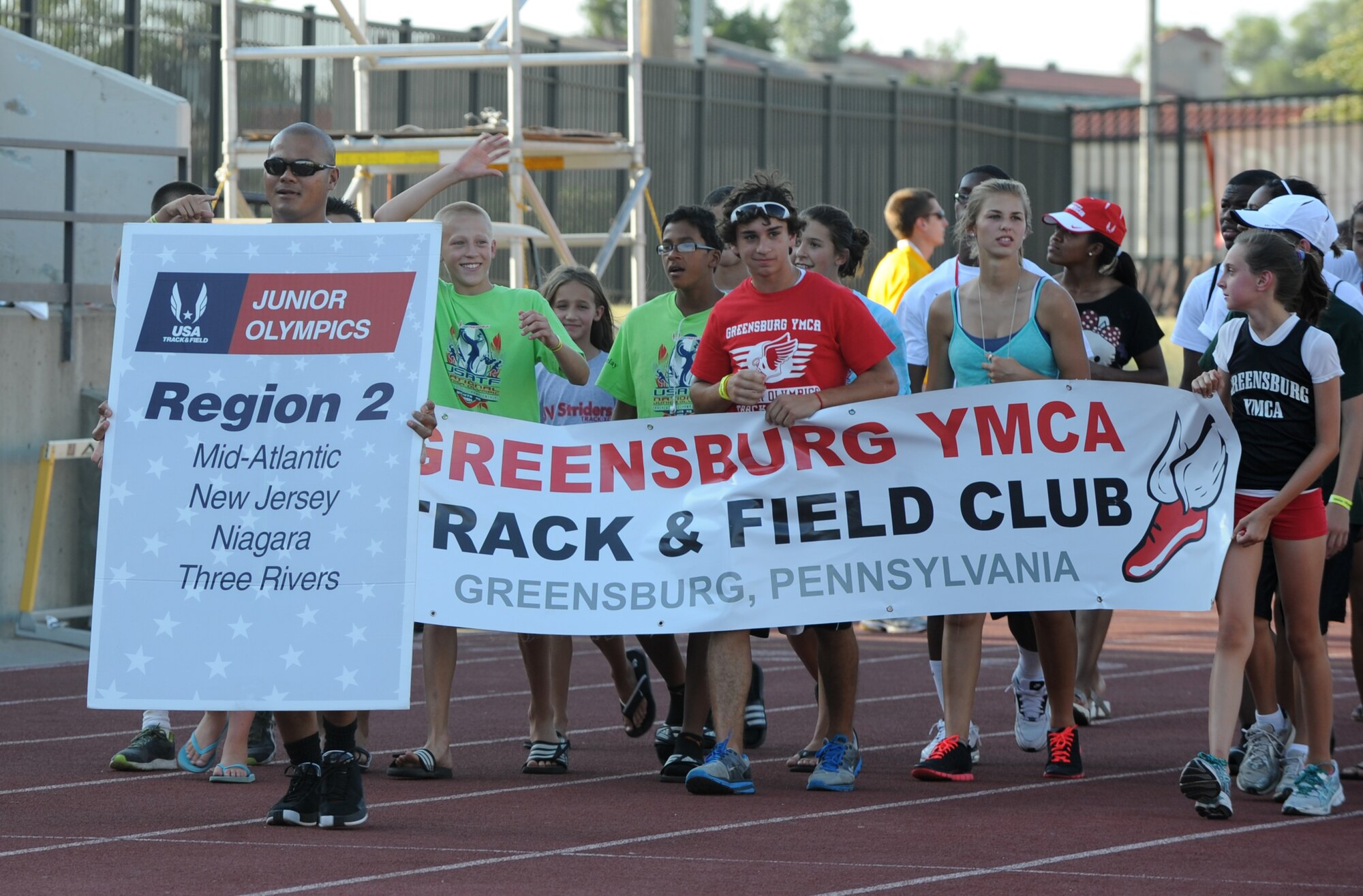 Sean Villagomez, 22nd Civil Engineer Squadron fire inspector, leads region 2 athletes for the USA Track and Field National Junior Olympic Track and Field Championships opening ceremony July 27, 2011, at Wichita State University, Kan.  Members of Team McConnell volunteered during the six day event to help more than 7,000 athletes, representing all 50 states, compete. (U.S. Air Force photo/ Airman 1st Class Katrina M. Brisbin)