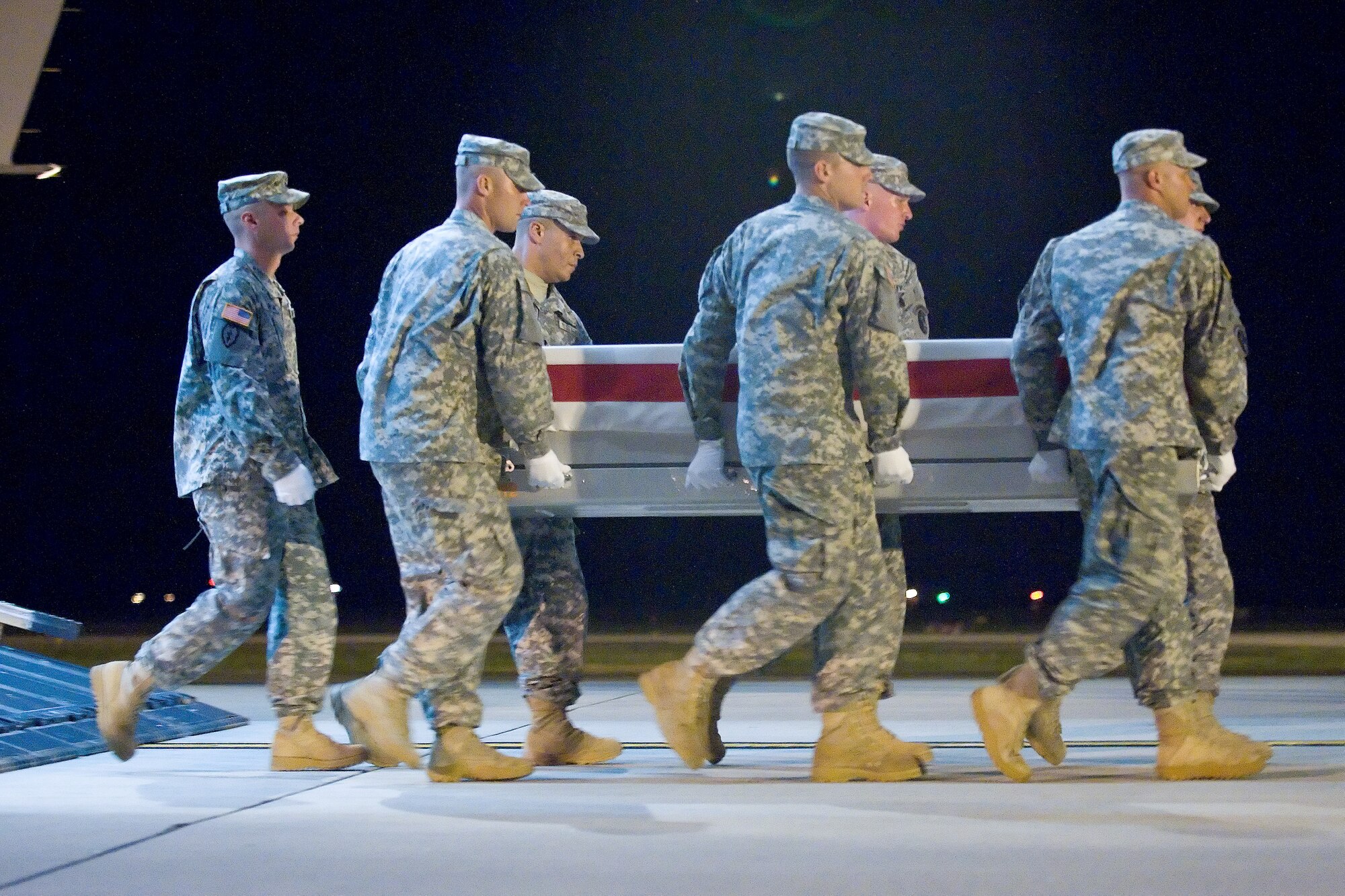 A U.S. Army carry team transfers the remains of Army Pfc. Brice M. Scott of Fort Benning, Ga., at Dover Air Force Base, Del., Aug. 1, 2011. Scott was assigned to the 4th Squadron, 4th Cavalry Regiment, 1st Heavy Brigade Combat Team, 1st Infantry Division, Fort Riley, Kan. (U.S. Air Force photo/Adrian Rowan)
