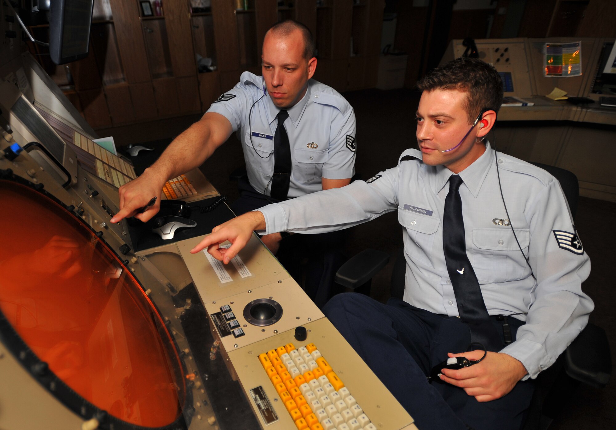 SPANGDAHLEM AIR BASE, Germany – Staff Sgts. Kirk Miles, left, and Robert Haldorsen, 52nd Operations Support Squadron ground radar controllers, pinpoint approaching aircraft within the local airspace here August 1. Ground radar controllers ensure the local area and surrounding airspace are controlled so aircraft can travel safely. (U.S Air Force photo/Airman 1st Class Dillon Davis)