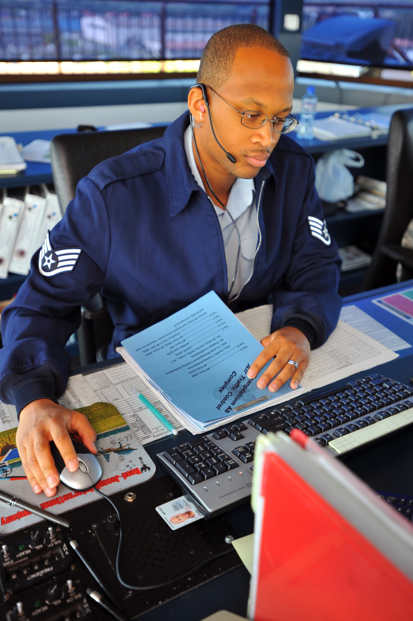 SPANGDAHLEM AIR BASE, Germany – Staff Sgt.Reginald Joseph, 52nd Operations Support Squadron air traffic controller, fills out forms and checklists while on watch supervisor duty inside the control tower here Aug. 1. Air traffic controllers ensure the base’s surrounding airspace is controlled so aircraft can take off and land safely. (U.S Air Force photo/Airman 1st Class Dillon Davis)