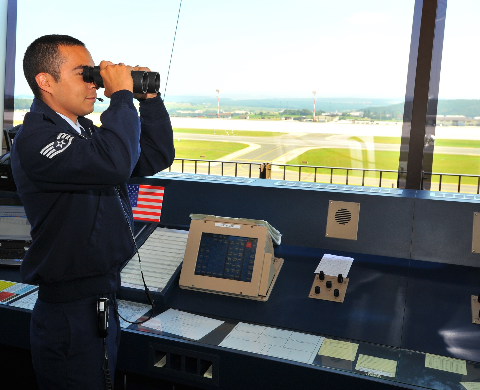 SPANGDAHLEM AIR BASE, Germany – Staff Sgt. Oscar Nunez, 52nd Operations Support Squadron air traffic controller, searches for aircraft from inside the control tower here Aug. 1. Air traffic controllers ensure the base’s surrounding airspace is controlled so aircraft can take off and land safely. (U.S Air Force photo/Airman 1st Class Dillon Davis)