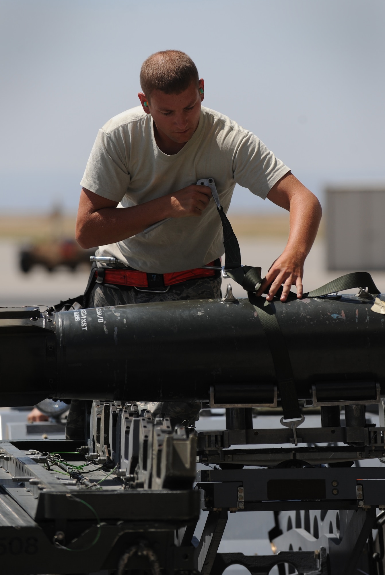 MOUNTAIN HOME AIR FORCE BASE, Idaho – Staff Sgt. Travis Hass, 389th Aircraft Maintenance Unit weapons load crew chief, secures an MK-82 bomb for travel during a weapons load competition here July 29. The 389th took third place with a time of 17:31. (U.S. Air Force photo by Staff Sgt. Gina Chiaverotti-Paige)