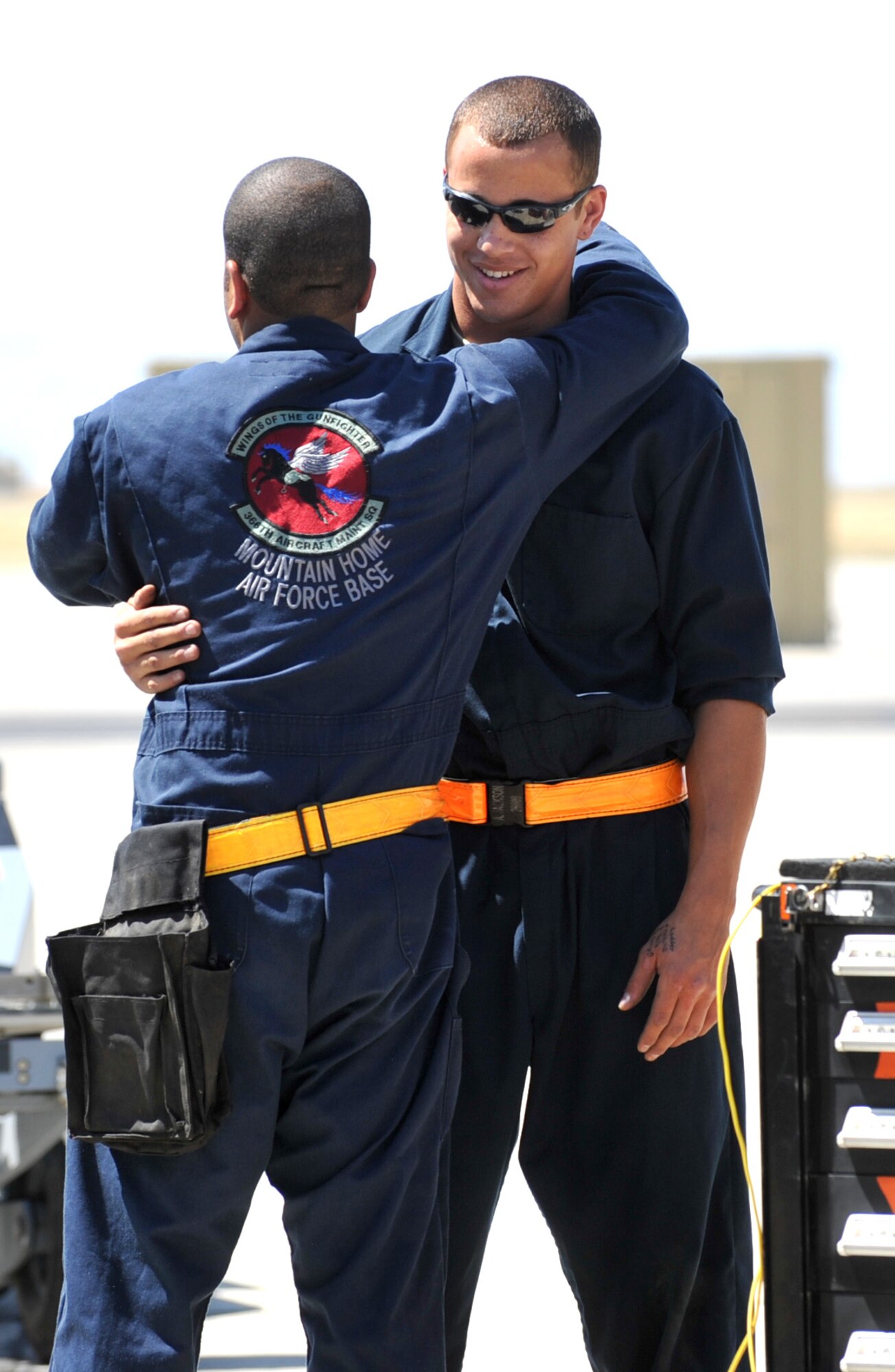 MOUNTAIN HOME AIR FORCE BASE, Idaho -- Senior Airman Andrew Jackson, 391st Aircraft Maintenance Unit weapons load team crewman two, hugs Airman 1st Class Oneil Hernandez, 391st AMU weapons load team crewman three, after completing the weapons load competition here July 29. Teams earn points by how quickly and properly they can load weapons onto the aircraft. (U.S. Air Force photo by Airman 1st Class Heather Hayward)