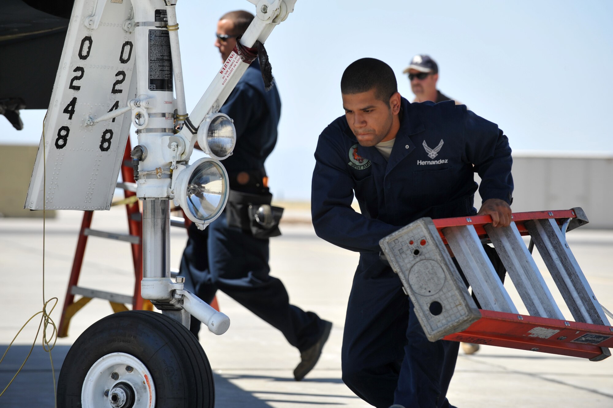 MOUNTAIN HOME AIR FORCE BASE, Idaho  – Airman 1st Class Oneil Hernandez, 391st Aircraft Maintenance Unit weapons load team crewman three, carries a ladder during the weapons load competition here July 29. The weapons load competition is held quarterly between the winning teams from the 391st, 389th and 428th Aircraft Maintenance Squadrons. (U.S. Air Force photo by Airman 1st Class Heather Hayward)