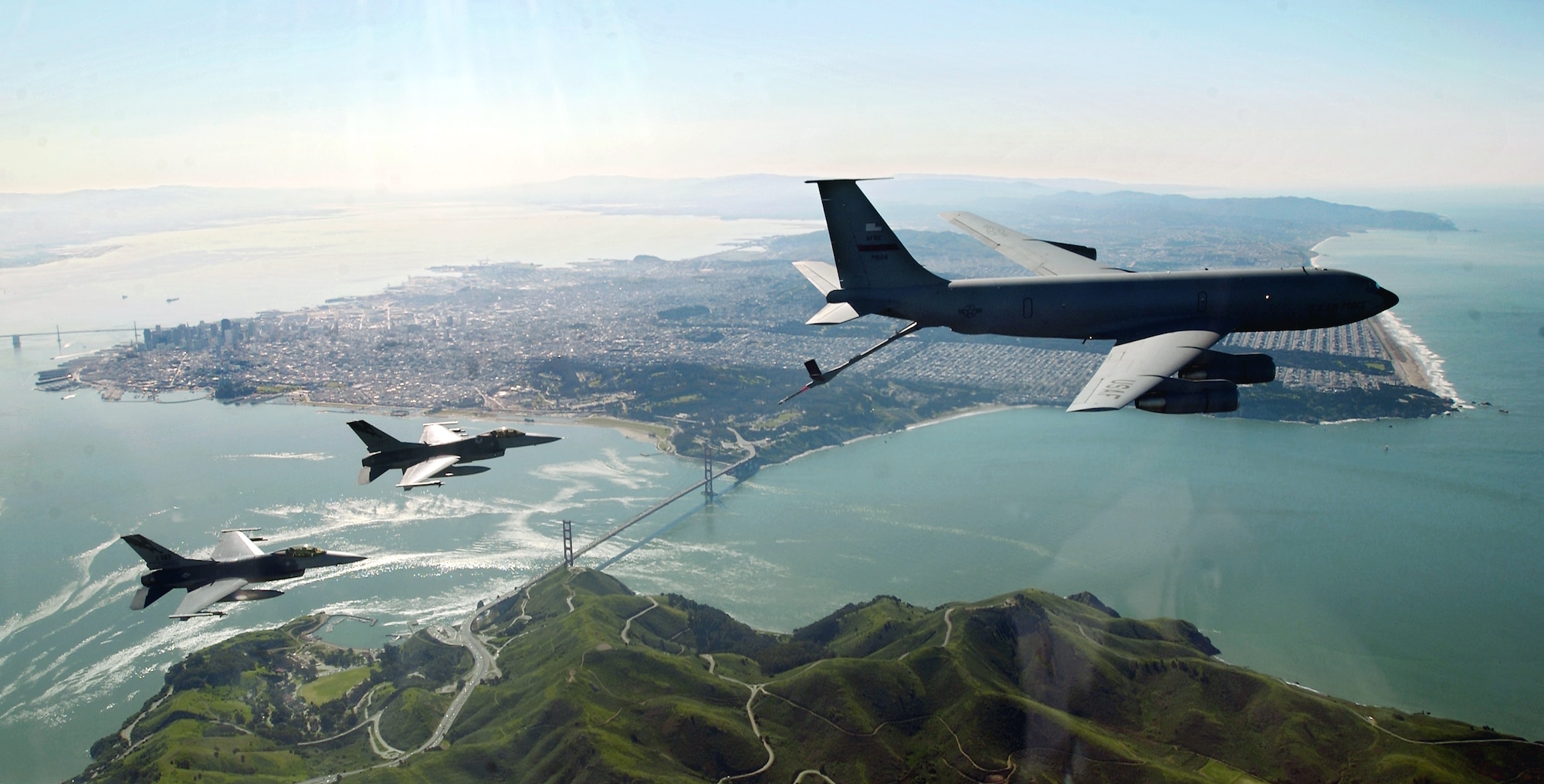 Flying over the San Francisco Bay, two F–16 Fighting Falcons move into a precontact position with a KC–135E Stratotanker before refueling during an Operation Noble Eagle training patrol. 