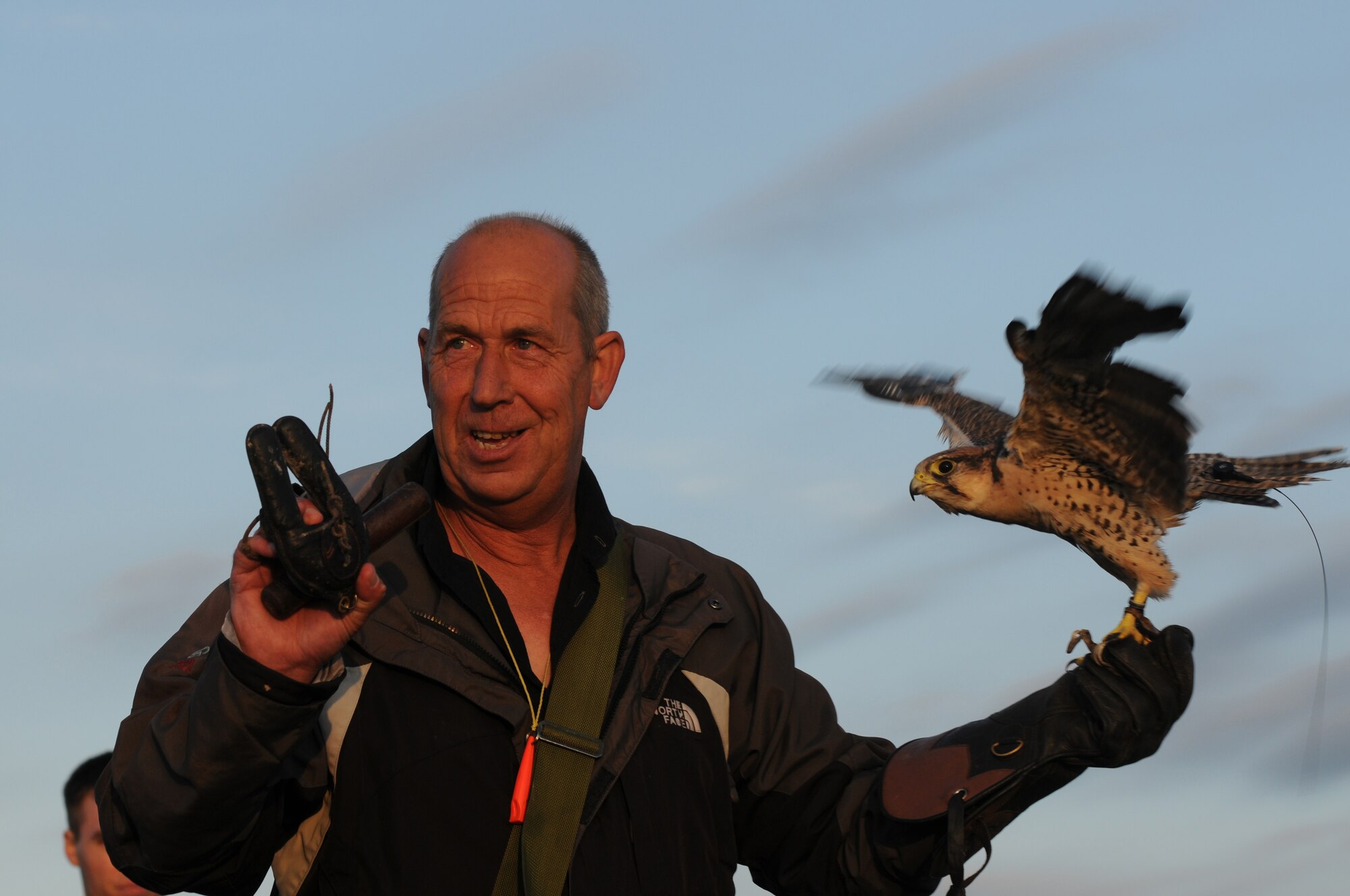 ROYAL AIR FORCE LAKENHEATH, England - Keith Mutton, Phoenix Bird Control falconer, presents Mustang, a 2-year-old lanner falcon, during a bird demonstration for the Honorary Commander's summer reception, July 29, 2011. The visitors, including seven new honorary commanders, were given a birds of prey demonstration, military working dog demonstration, F-15 take-offs and landings, de-contamination exercise, a barbecue amoung other activities. (U.S. Air Force photo/Airman Cory D. Payne)