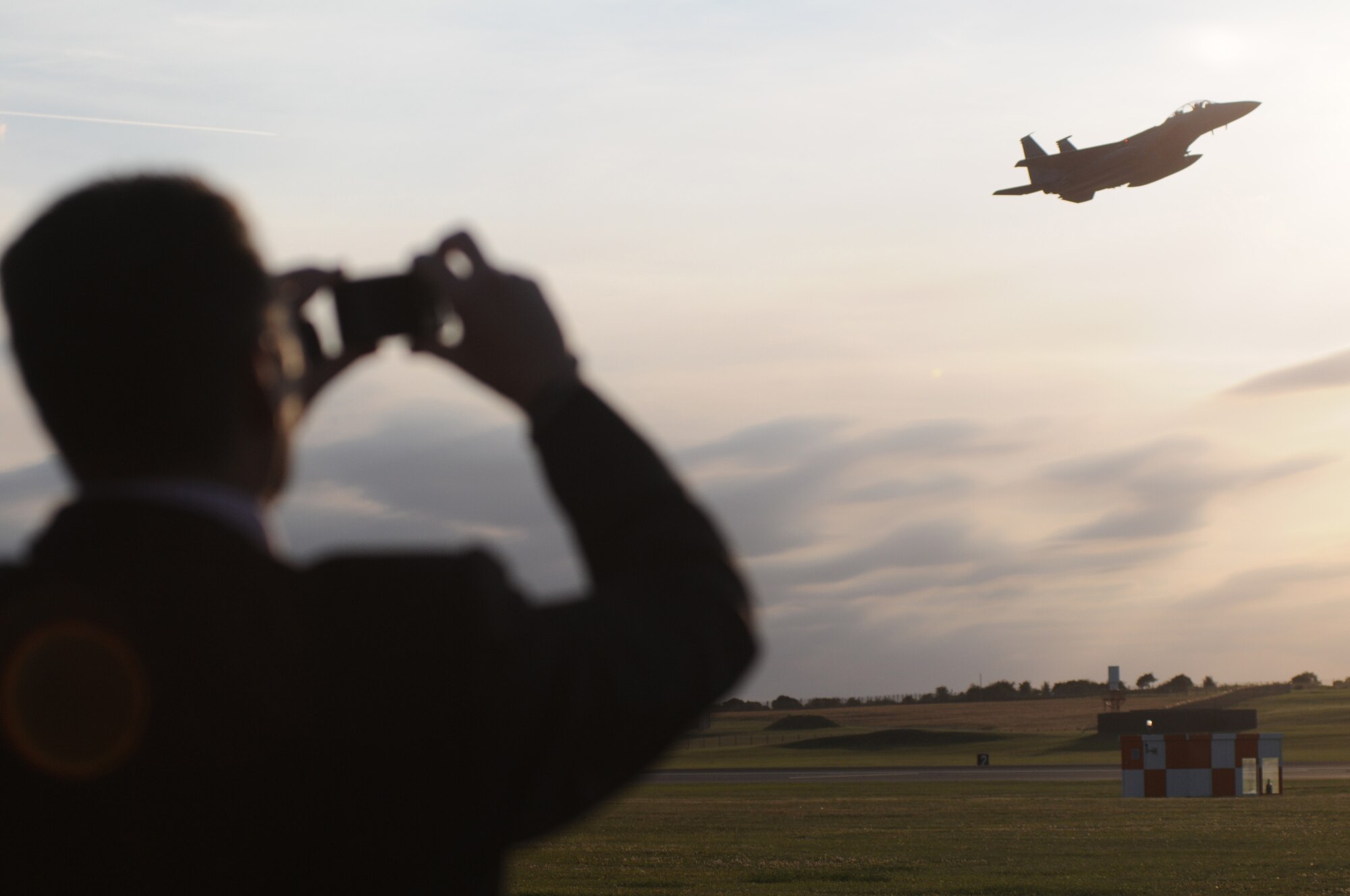 ROYAL AIR FORCE LAKENHEATH, England - Clive Springett, 48th Communications Squadron honorary commander, takes photos of an F-15E Strike Eagle during the Honorary Commander's summer reception on RAF Lakenheath, July 29, 2011. The visitors, including seven new honorary commanders, were given a birds of prey demonstration, military working dog demonstration, F-15 take-offs and landings, de-contamination exercise, and a barbecue among other activities. (U.S. Air Force photo/Airman Cory D. Payne)