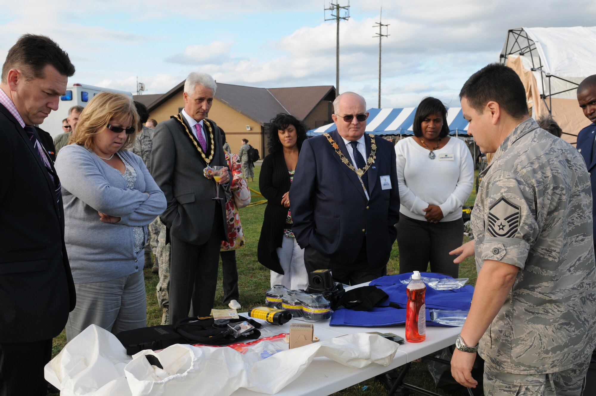ROYAL AIR FORCE LAKENHEATH, England - Master Sgt. Apolonio Santos, 48th In-Patient Care Squadron noncommissioned officer in charge, gives a presentation of tools a decontamination team uses during the Honorary Commander's summer reception on RAF Lakenheath, July 29, 2011. The visitors, including seven new honorary commanders, were given a birds of prey demonstration, military working dog demonstration, F-15 take-offs and landings, de-contamination exercise, and a barbecue among other activities. (U.S. Air Force photo/Airman Cory D. Payne)