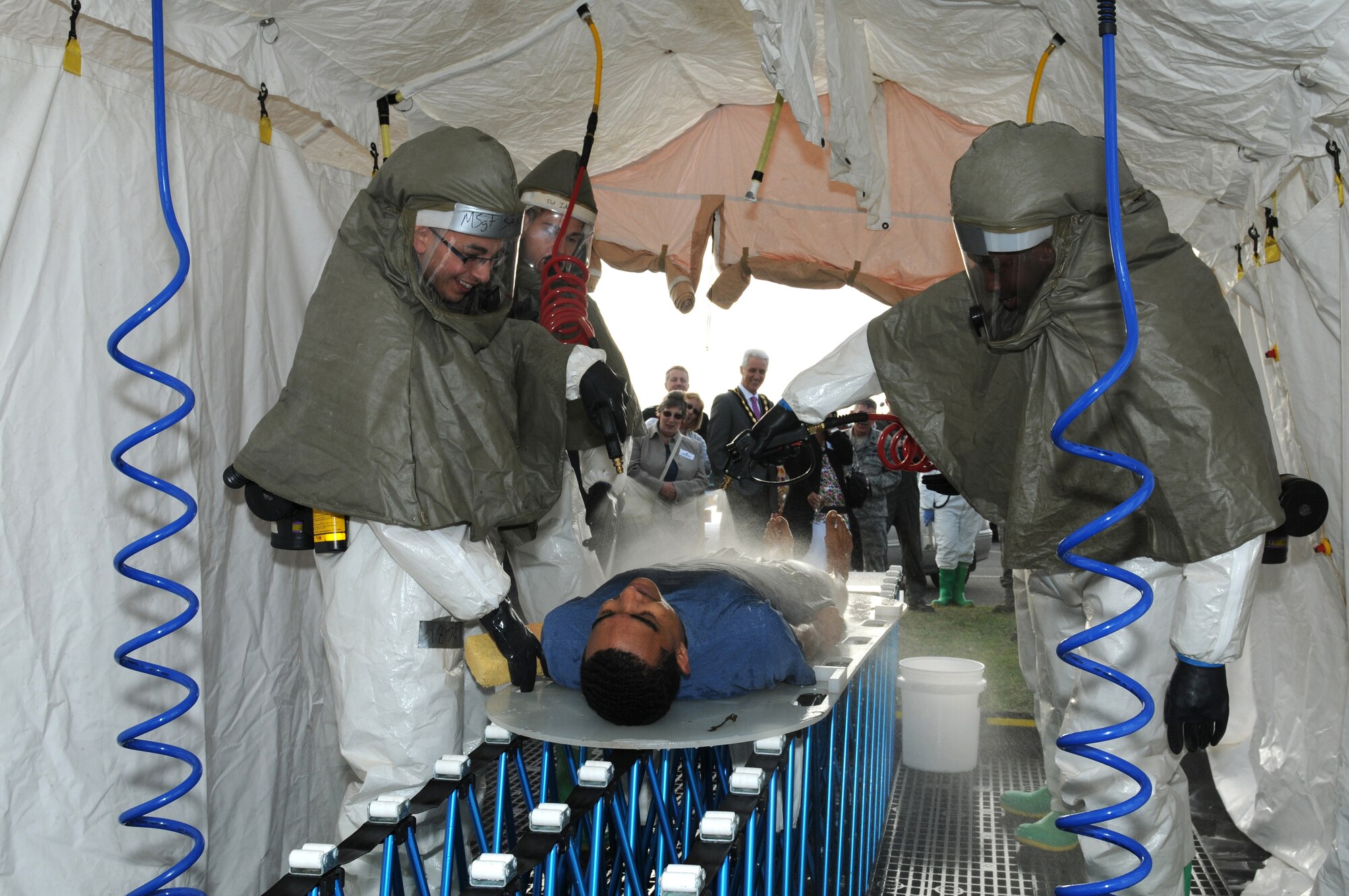 ROYAL AIR FORCE LAKENHEATH, England - Airmen from the 48th Medical Group demonstrate a decontamination tent during the Honorary Commander's summer reception on RAF Lakenheath, July 29, 2011. The visitors, including seven new honorary commanders, were given a birds of prey demonstration, military working dog demonstration, F-15 take-offs and landings, de-contamination exercise, and a barbecue among other activities. (U.S. Air Force photo/Airman Cory D. Payne)