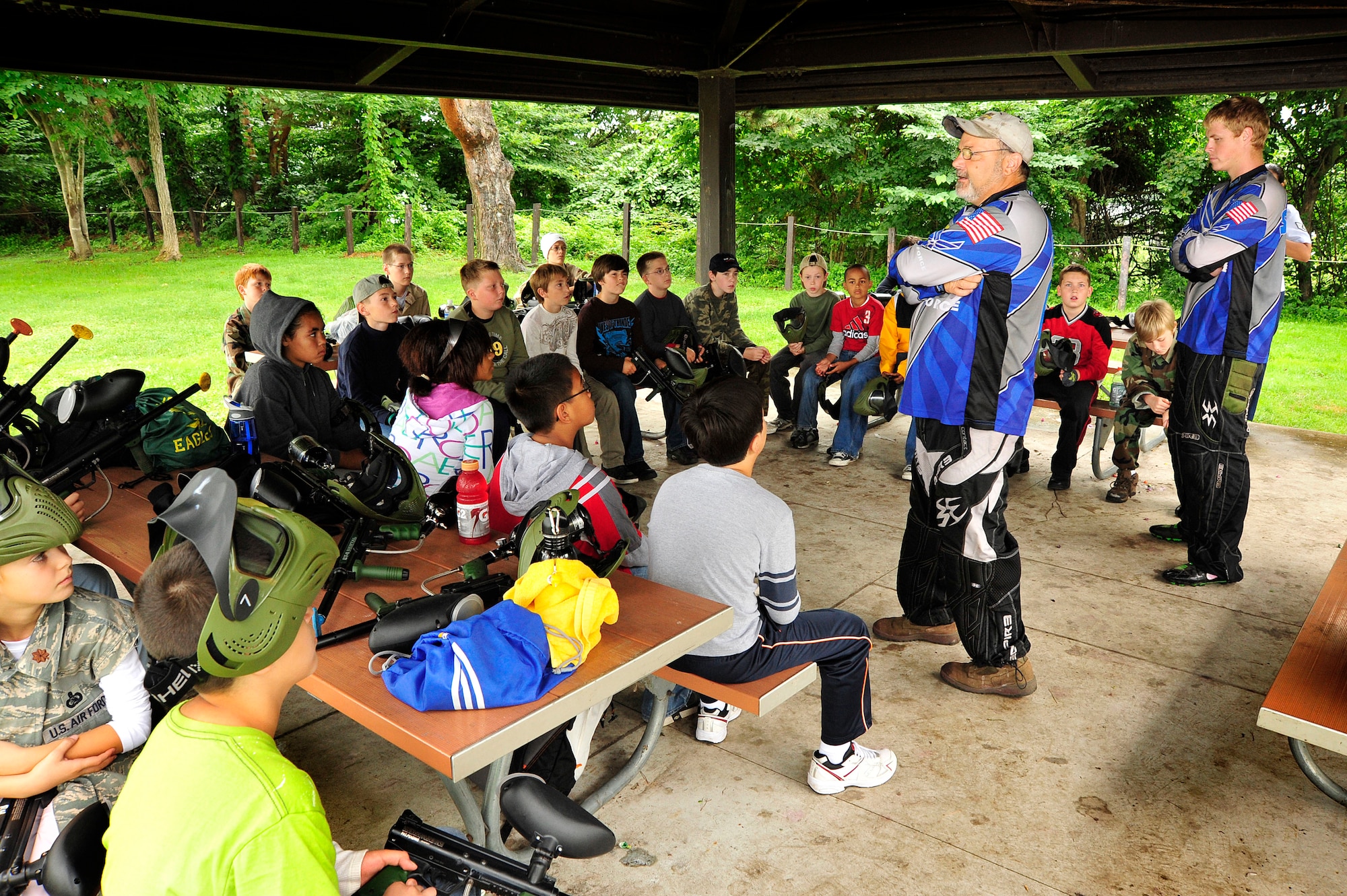 MISAWA AIR BASE, Japan -- Tim Gray, left, and Austin Stonecash, right, Youth Paintball Summer Camp instructors, go over safety rules for playing paintball, Aug 1. When the rules are followed Mr. Gray believes, paintball is the safest sport in the world. (U.S. Air Force photo/Staff Sgt. Nathan Lipscomb/Released)
