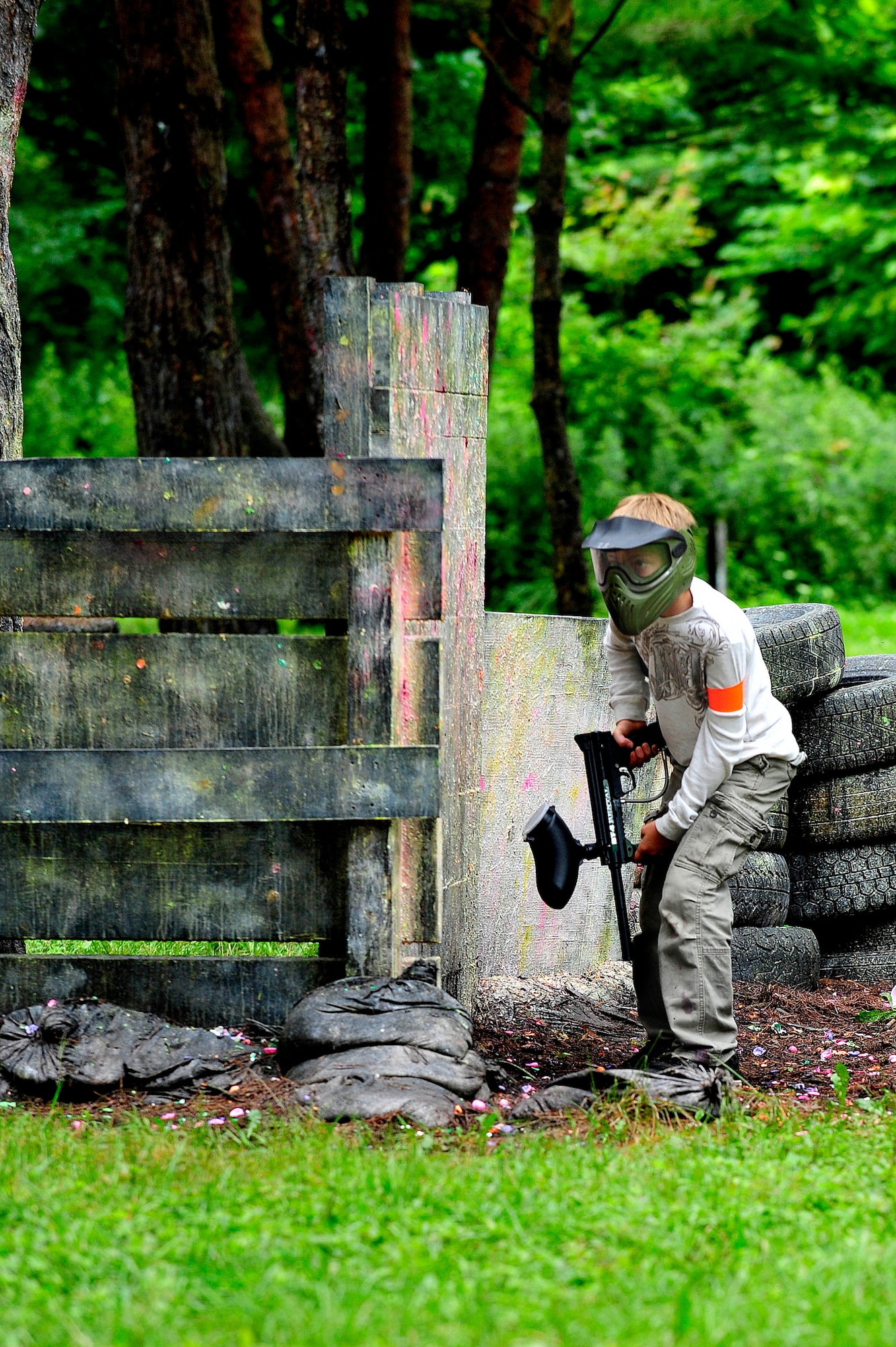 MISAWA AIR BASE, Japan -- Noah Ingrum, son of Tech. Sgt. Darrel Ingrum, 35th Maintenance Squadron, looks around the corner of a bunker as he moves closer to the opposing team during the Youth Paintball Summer Camp, Aug. 1. The instructors use the time between games to talk with the children about overcoming everyday challenges in life. (U.S. Air Force photo/Staff Sgt. Nathan Lipscomb/Released)  