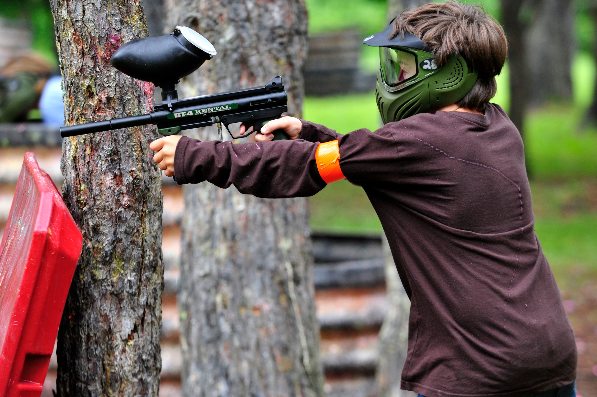 MISAWA AIR BASE, Japan -- Grant Axley, son of Capt. Gary Axley, 35th Operations Group, shoots at opponents during the Youth Paintball Summer Camp, Aug. 1. Youth participating in the camp are taught how to safely play the game of paintball while learning life lessons, such as, overcoming fear, making friends and team work. (U.S. Air Force photo/Staff Sgt. Nathan Lipscomb/Released)