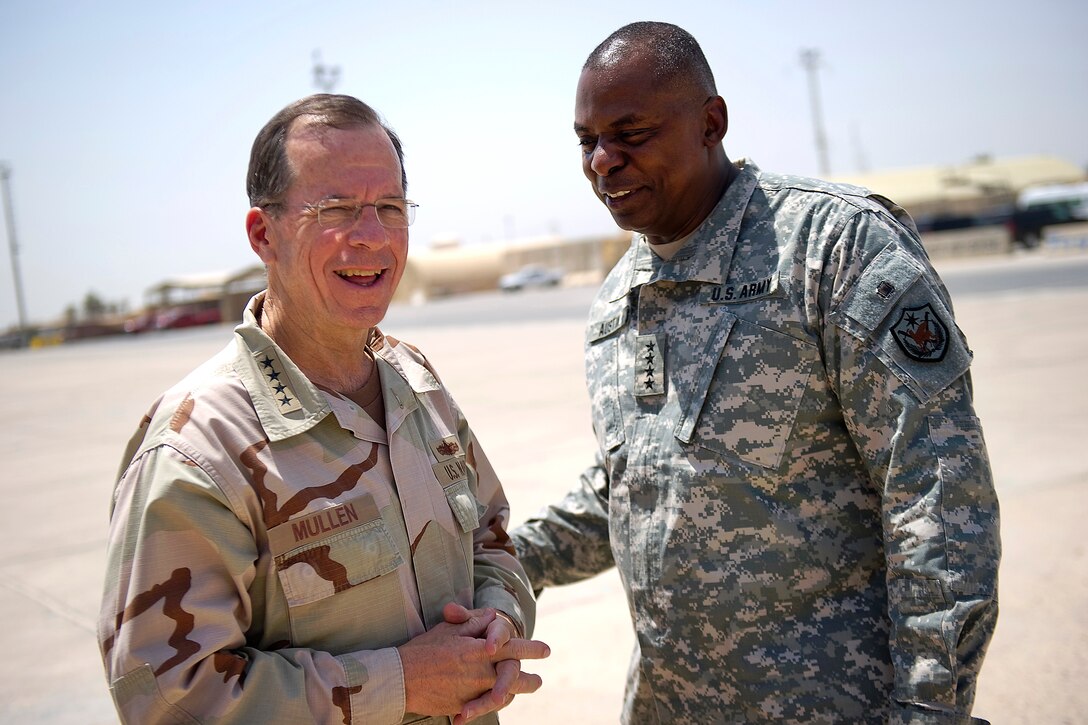U.S. Army Gen. Lloyd Austin, commander of U.S. Forces-Iraq, bids farewell to U.S. Navy Adm. Mike Mullen, chairman of the Joint Chiefs of Staff, at Al-Asad Air Base, Iraq, Aug. 2, 2011.