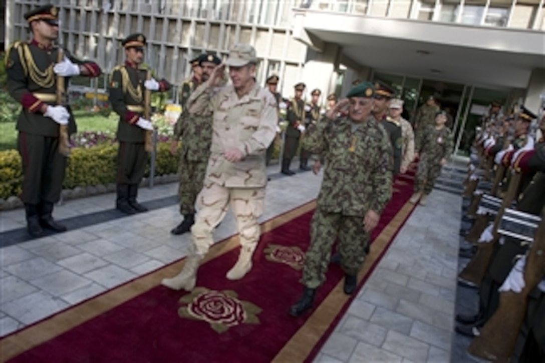 Chairman of the Joint Chiefs of Staff Adm. Mike Mullen and Afghan National Army Chief of the General Staff Gen. Karim depart the Ministry of Defense in Kabul, Afghanistan, on July 31, 2011.  Mullen is on a five-day USO tour with comedian Jon Stewart, NBA legend Karl Malone and magician David Blane visiting troops in Afghanistan and Iraq.  