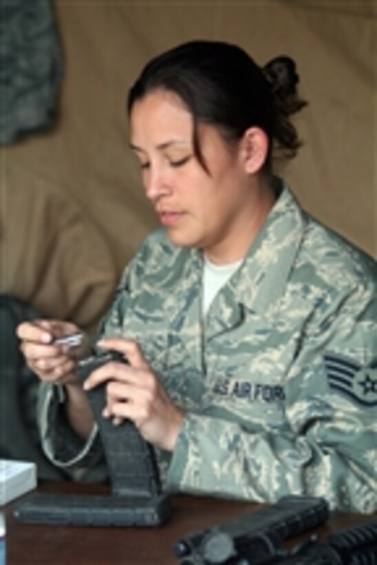 U.S. Air Force Staff Sgt. Lucinda Collins, with the 421st Combat Training Squadron at Joint Base McGuire-Dix-Lakehurst, N.J., prepares an ammunition clip for the security forces tactics team competition for Air Mobility Rodeo at Joint Base Lewis-McChord, Wash., on July 26, 2011.  The Air Mobility Rodeo is the Air Mobility Command?s biennial readiness competition.  It focuses on improving the professional core abilities of air mobility forces from the U.S. Air Force and Air Force Reserve as well as allied nations.  