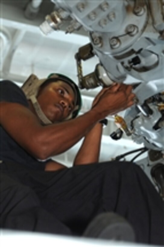 U.S. Navy Petty Officer 3rd Class Gavin Persaud cleans and inspects the rotor assembly of an MH-60S Seahawk helicopter assigned to Helicopter Sea Combat Squadron 9 in the hangar bay aboard the aircraft carrier USS George H.W. Bush (CVN 77) in the Arabian Sea on July 27, 2011.  The George H.W. Bush was deployed to the U.S. 5th Fleet area of responsibility conducting maritime security operations and support missions as part of operations Enduring Freedom and New Dawn.  