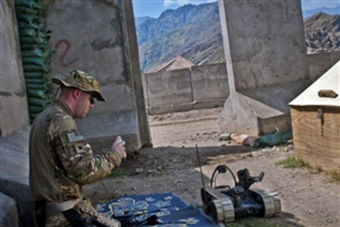 U.S. Army Spc. Andrew B. Clemen gets a refresher course on a Pacbot 310 EOD robot at Combat Outpost Honaker-Miracle in eastern Afghanistan's Kunar province, Aug. 1, 2011. Clement is an explosive ordnance disposal technician assigned to the 25th Infantry Division's 129th Ordnance Company, 3rd Brigade Combat Team.