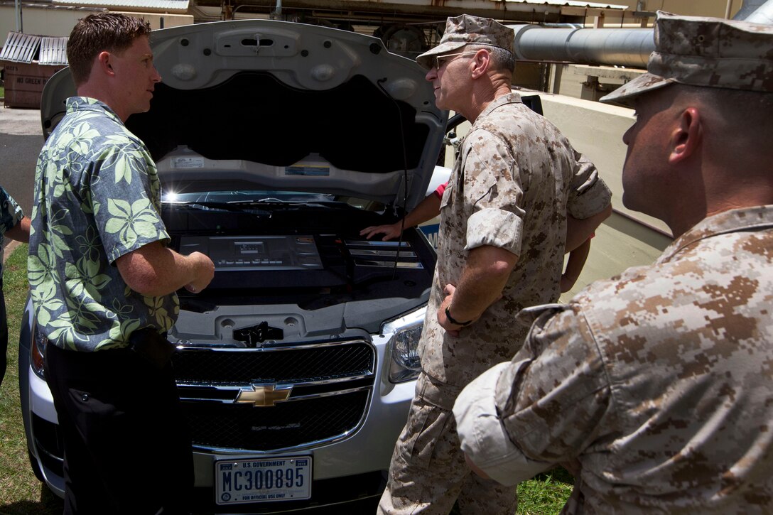 Lt. Gen Duane D. Thiessen, commander of U.S. Marine Corps Forces, Pacific, and Chris Colquitt, a General Motors site leader, discuss the capabilities of the hydrogen fuel-cell vehicle here Aug. 3. In an effort to be more energy efficient, military installations in Hawaii will increase the use of hydrogen fuel-celled vehicles.