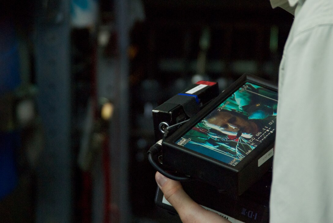 Capt. Kyle Larson, 53rd Weather Reconnaissance Squadron Aerial Reconnaissance Weather Officer, is "interviewed" about the training he received while flying a mission into Tropical Storm Don July 29. (U.S. Air Force photo by Capt. J. Justin Pearce)