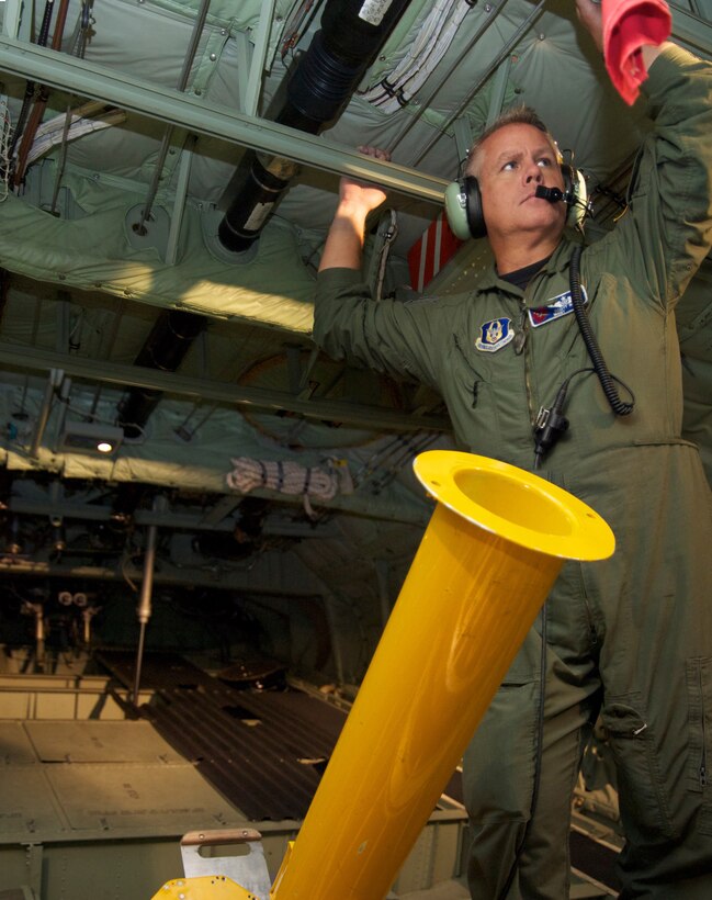 Master Sgt. Scott Blair, 53rd Weather Reconnaissance Squadron dropsonde operator, awaits the signal to deploy a weather bouy during the reconnaissance flight into Tropical Storm Don July 29. (U.S. Air Force photo by Capt. J. Justin Pearce)