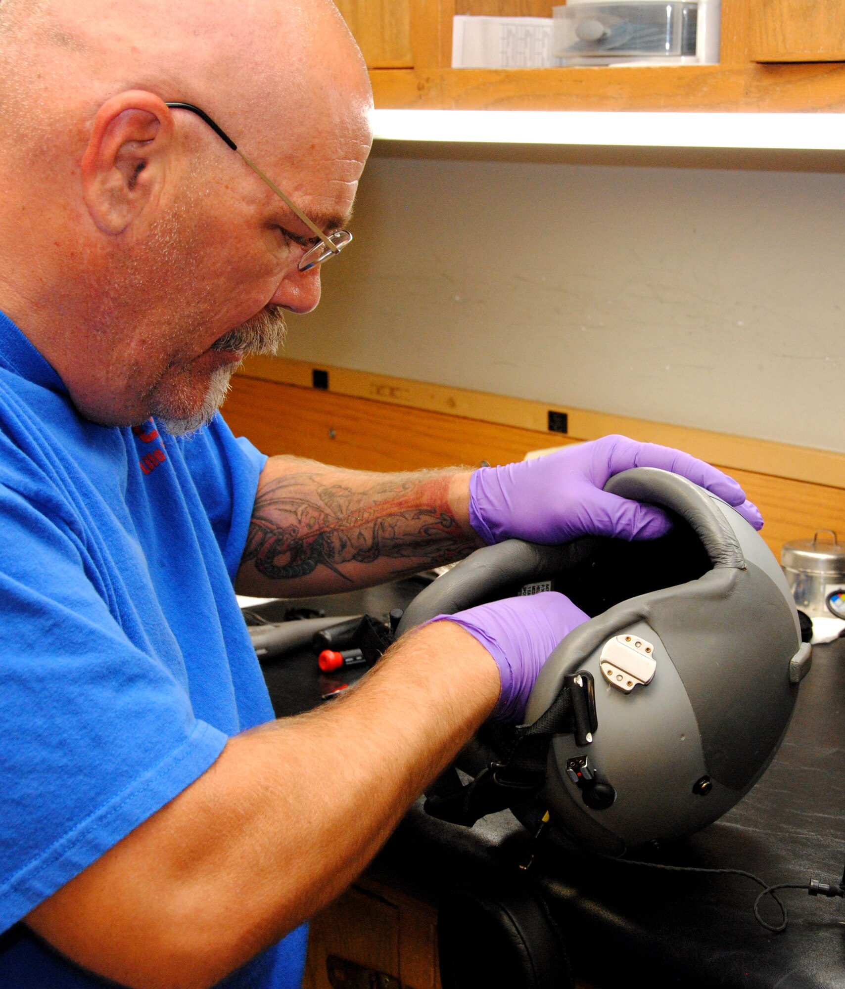 John McFadden, one of 15 technicians working at the CSC Applied Technologies Life Support section, cleans a helmet during the once-a-month maintenance inspections performed on every pilot’s helmet at Vance AFB, Okla. (U.S. Air Force photo/ Jessica Gibson) 