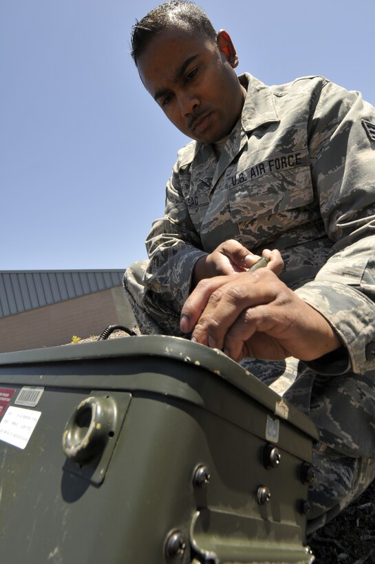 Senior Airman Deepak Prasad, a ground radio technician assigned to the 129th Communications Flight, conducts operational check on a ground radio TRC-176 communication system via satelite channel at Moffett Federal Airfield, Calif., July 10, 2011.  Prasad is featured in this month's Portrait of a Professional. (California Air National Guard photo by Airman 1st Class John Pharr)